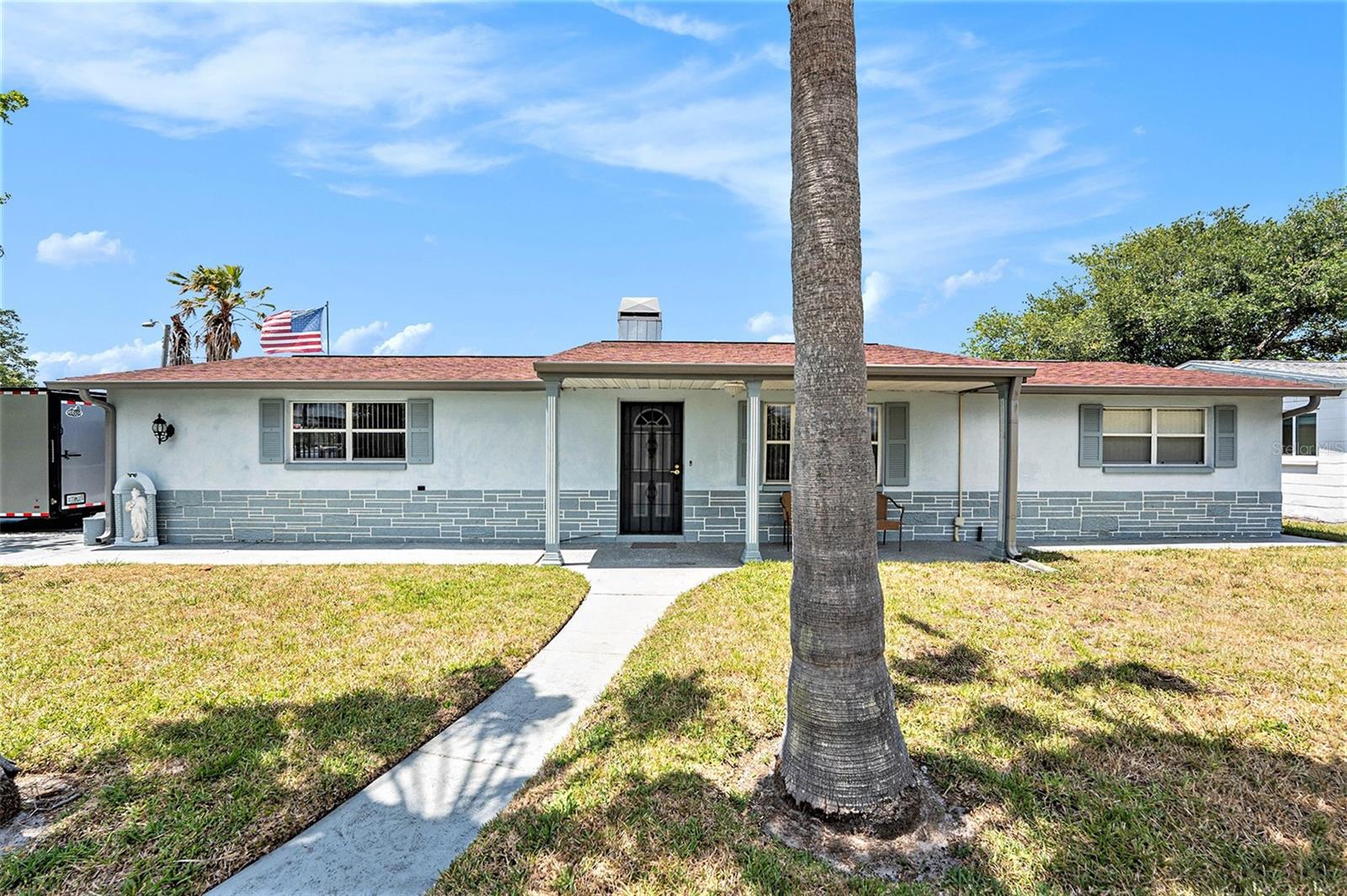 Welcome Home! This corner lot, low-maintenance block home, untouched by last year’s hurricanes