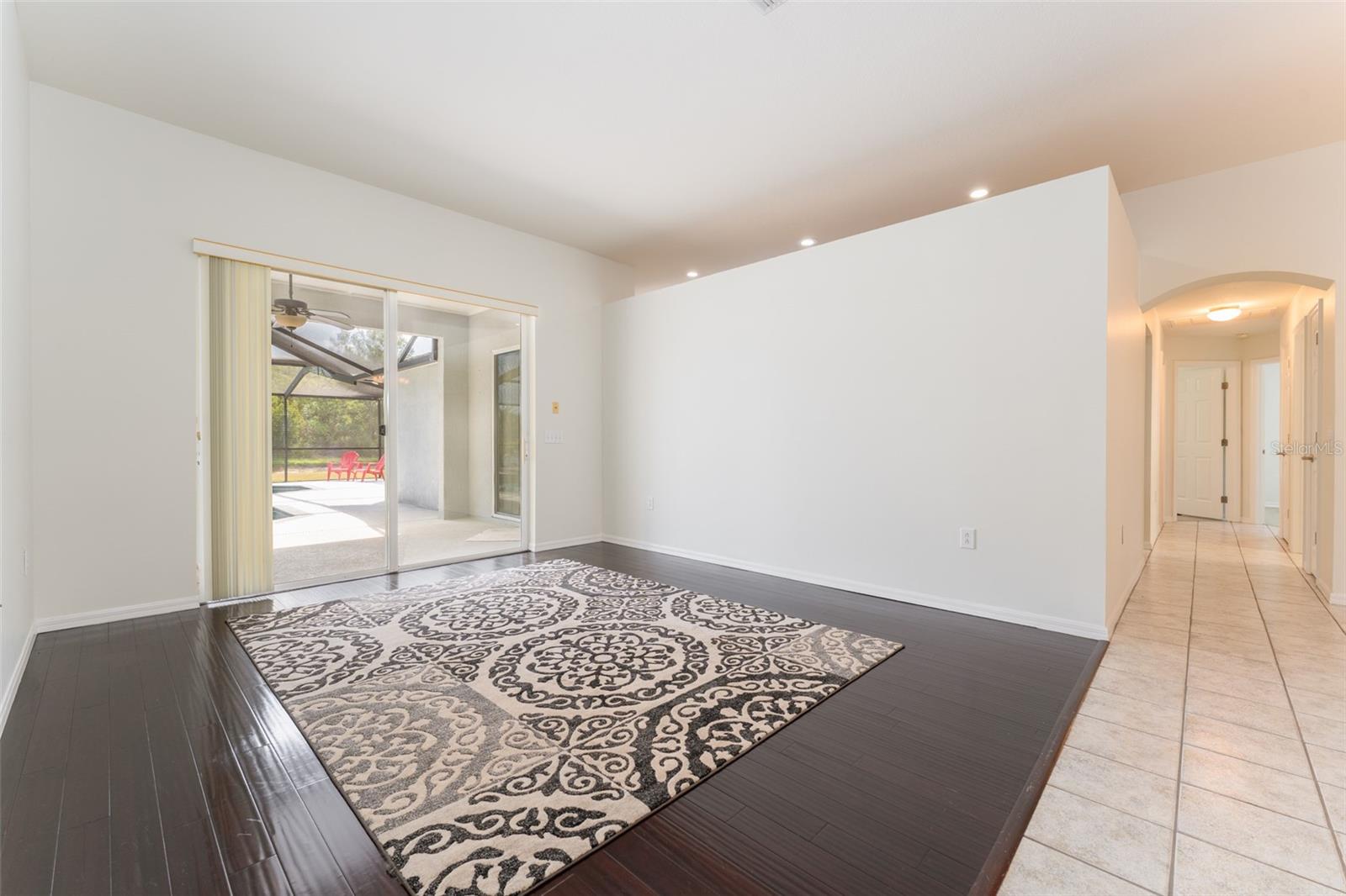 another view of the formal living room with view of the hallway leading to the kitchen, bedrooms 2 & 3, the 2nd full bath & laundry room