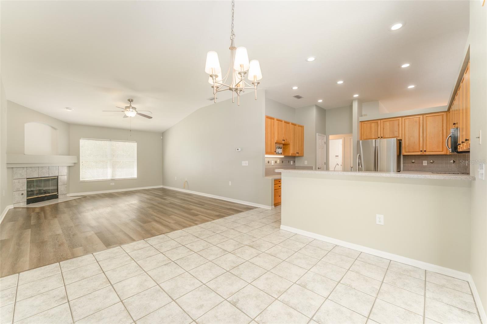 the eat in area of the kitchen with a view of the family room with it gas fireplace