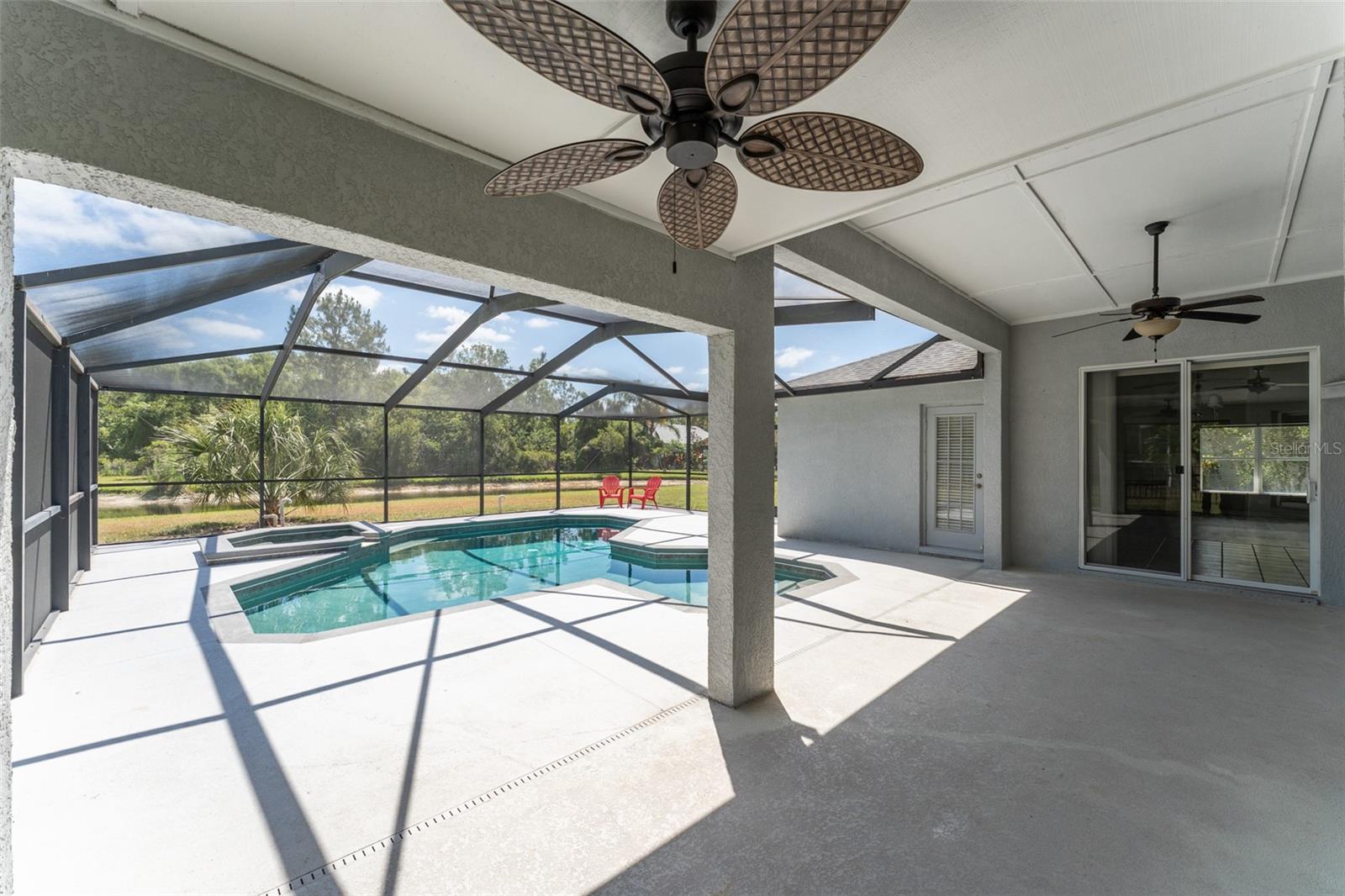 another view under the covered potion of the lanai showing access to the kitchen & 3 rd bath