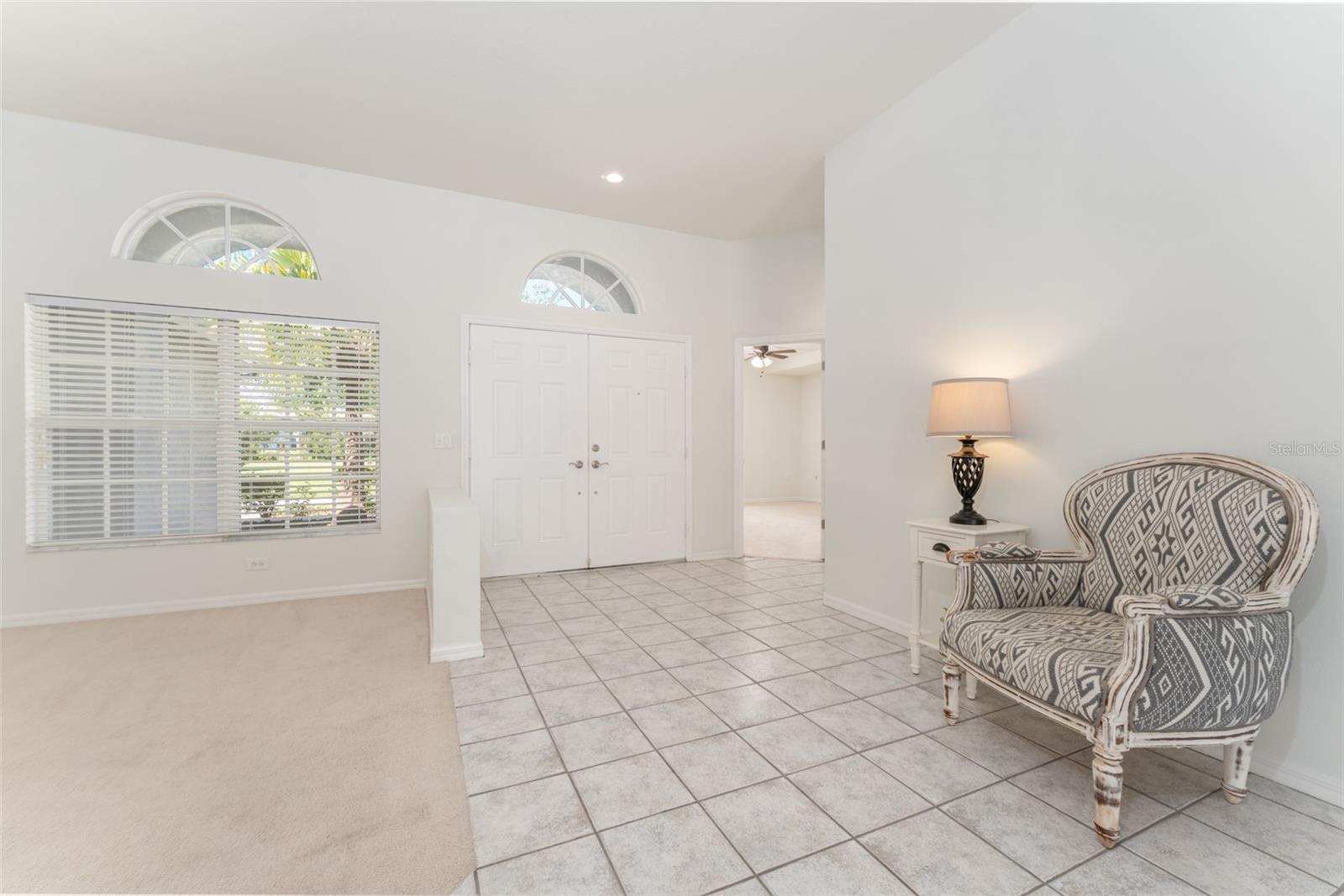 view of the foyer from the formal living room. The entrance to the office is right of the front doors.