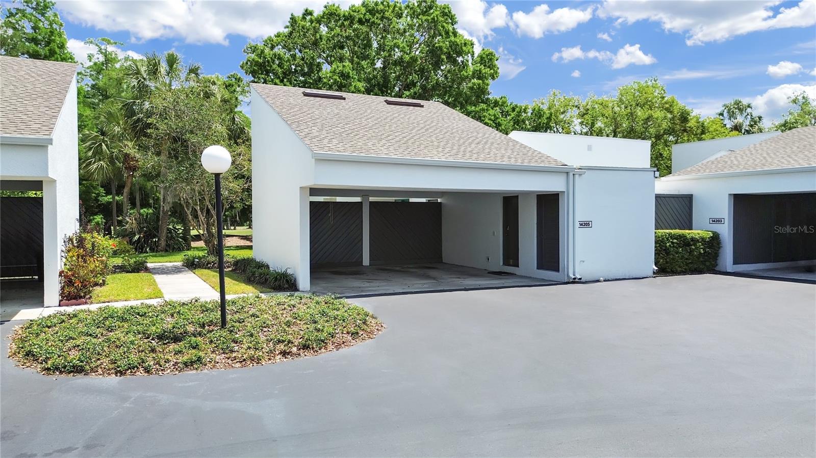 This single story condo lives like a Villa and includes an attached 2-Car covered Carport (seen here).