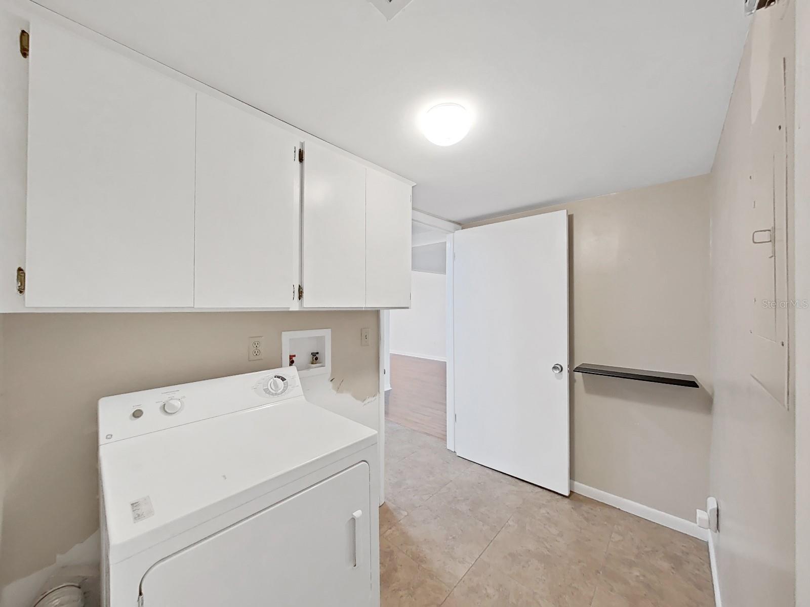 Laundry Room, just off the kitchen, with cabinetry - Dryer included.