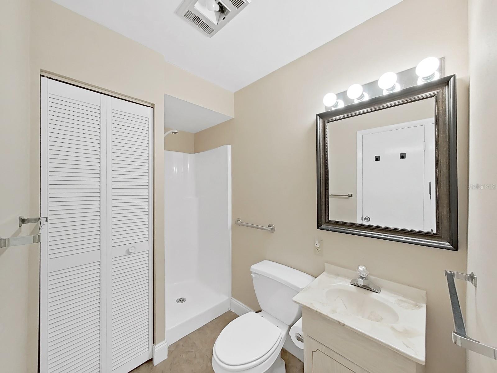 Bathroom 2 with step-in shower and storage closet (with Water Heater).