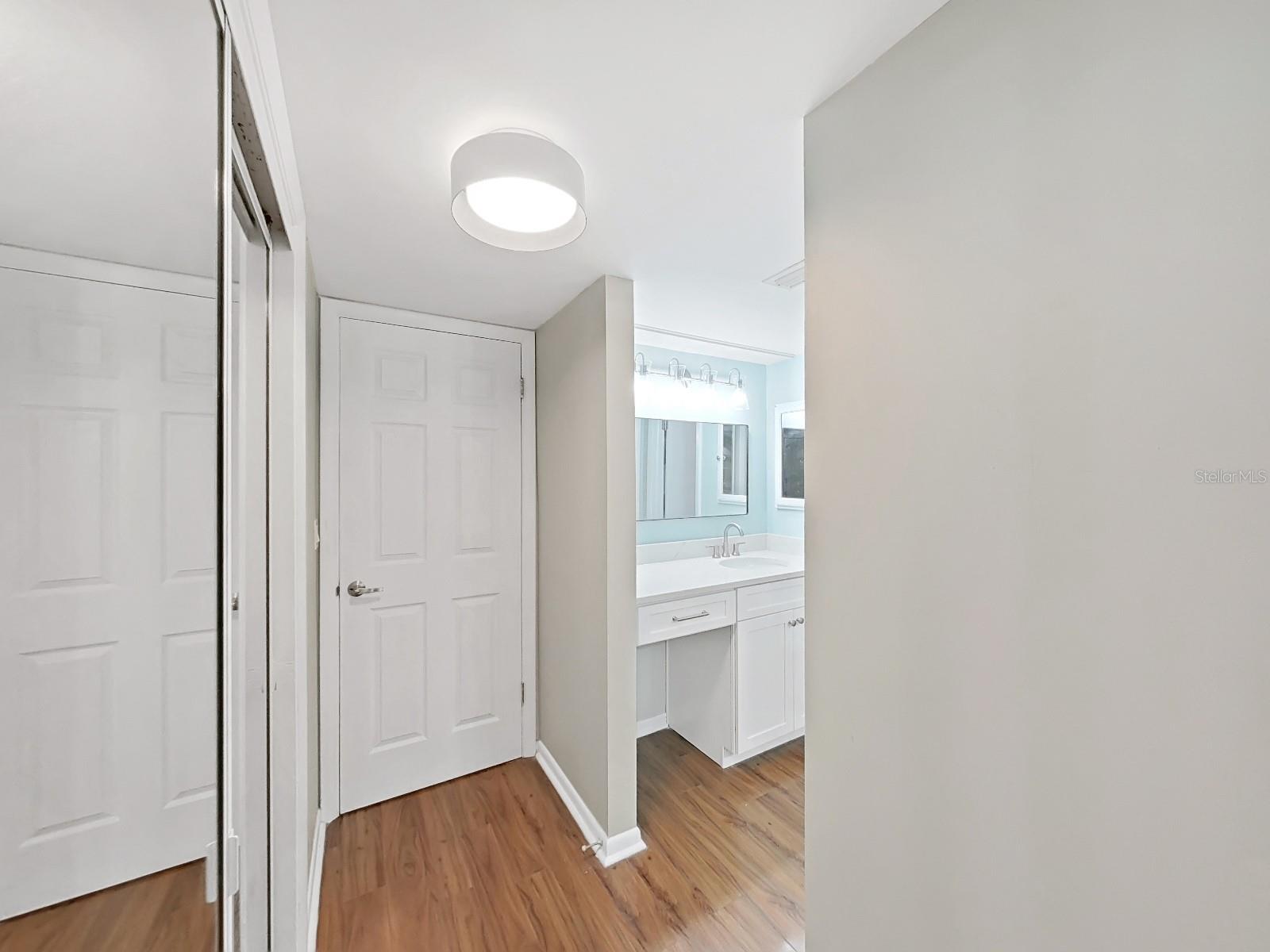 Updated Primary Bathroom with vanity area, storage closets and separate toilet/shower room.