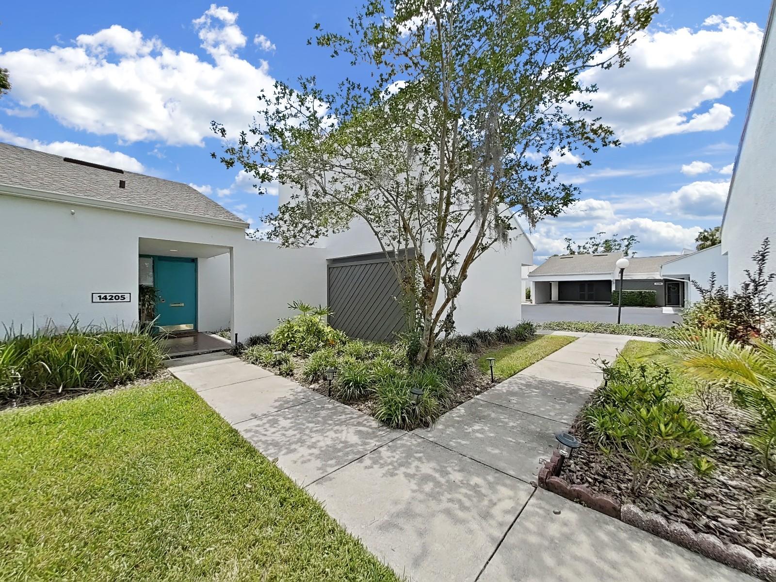 Winding walkway from parking lot to front door offers views of the golf course!