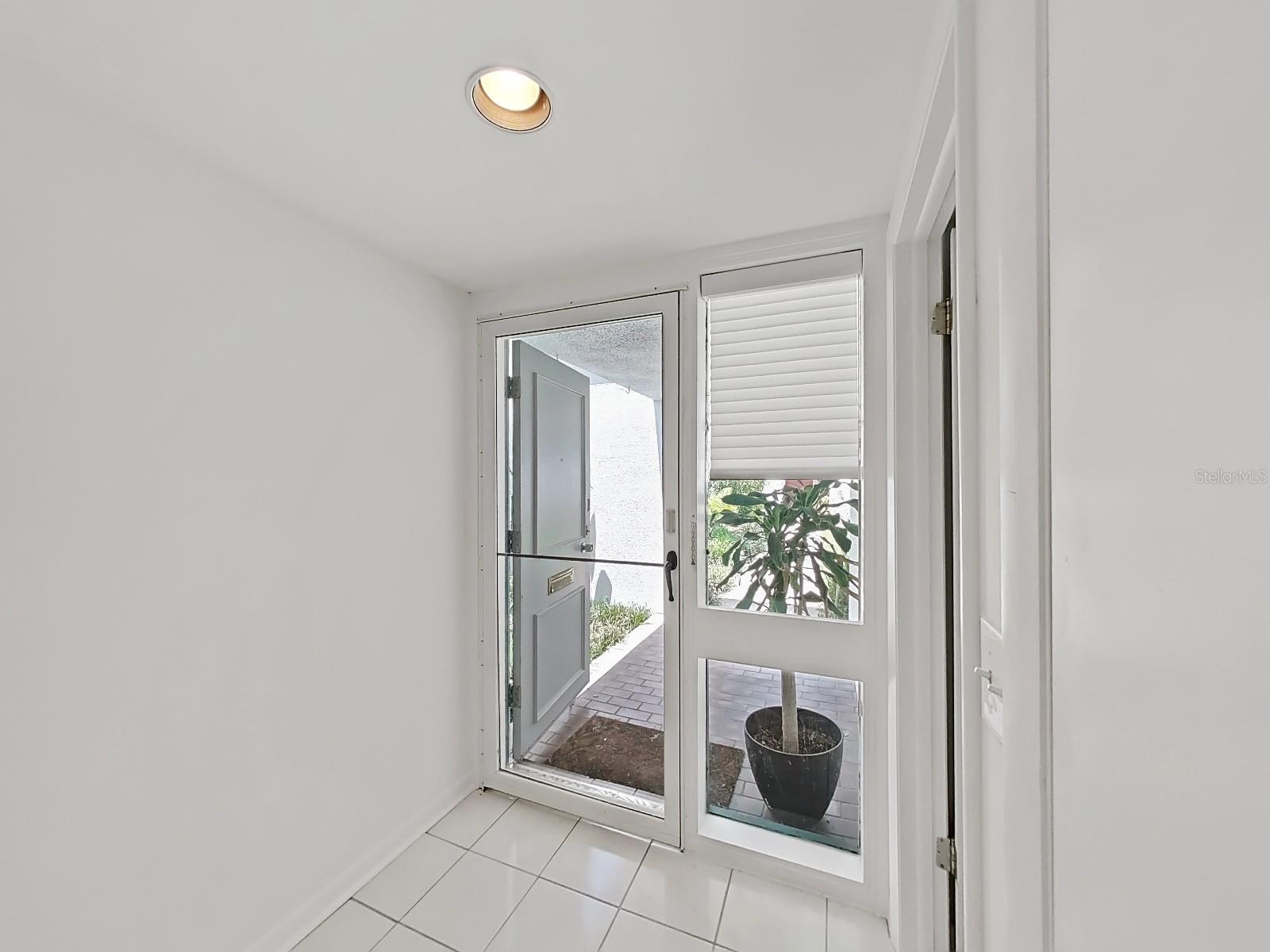 Foyer entry with screened door for cool, breezy days!