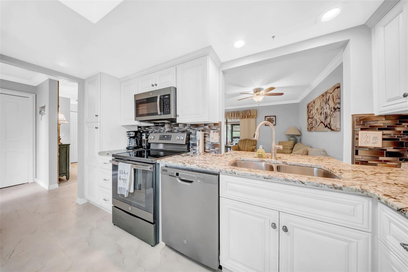 Stainless steel appliances, granite counters, and plenty of cabinets
