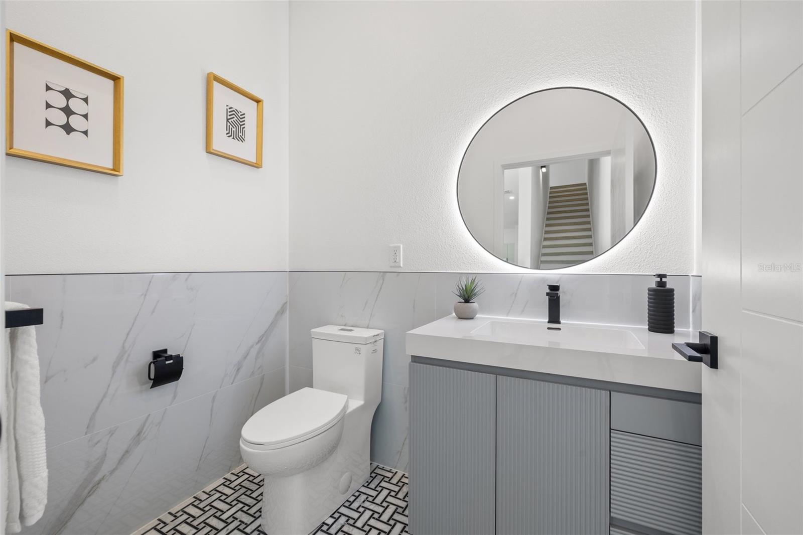 All bathrooms have soft-lit mirrors and custom vanities.