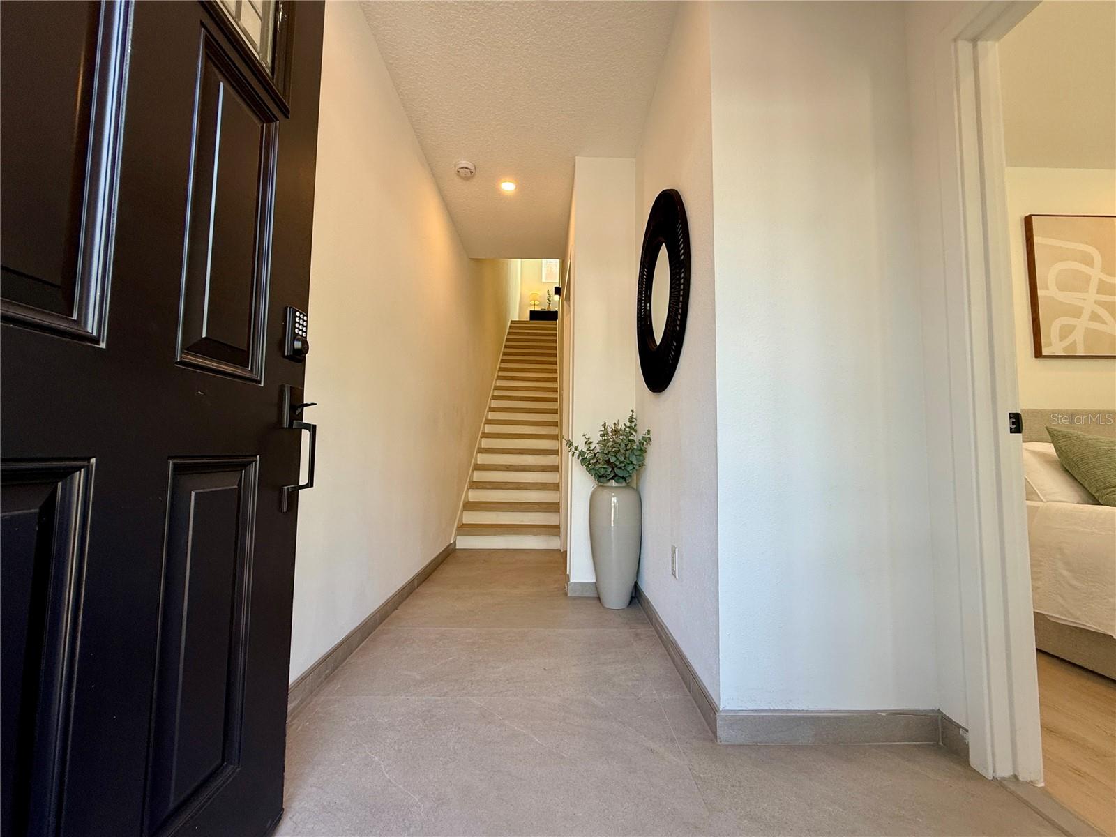 Welcoming entry - 10ft ceilings and a bedroom off the first floor.