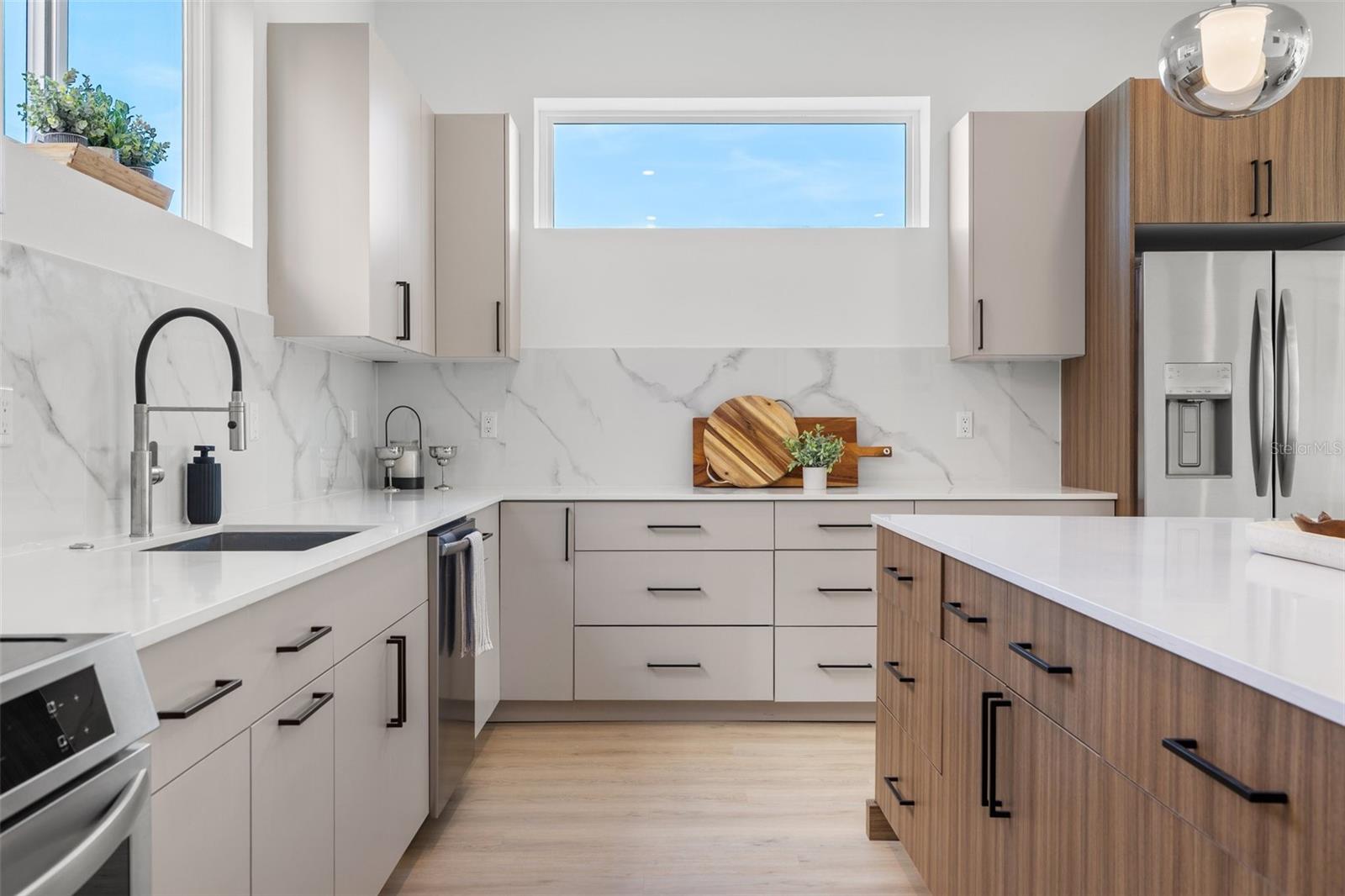 2-tone contemporary cabinets with several deep drawers.
