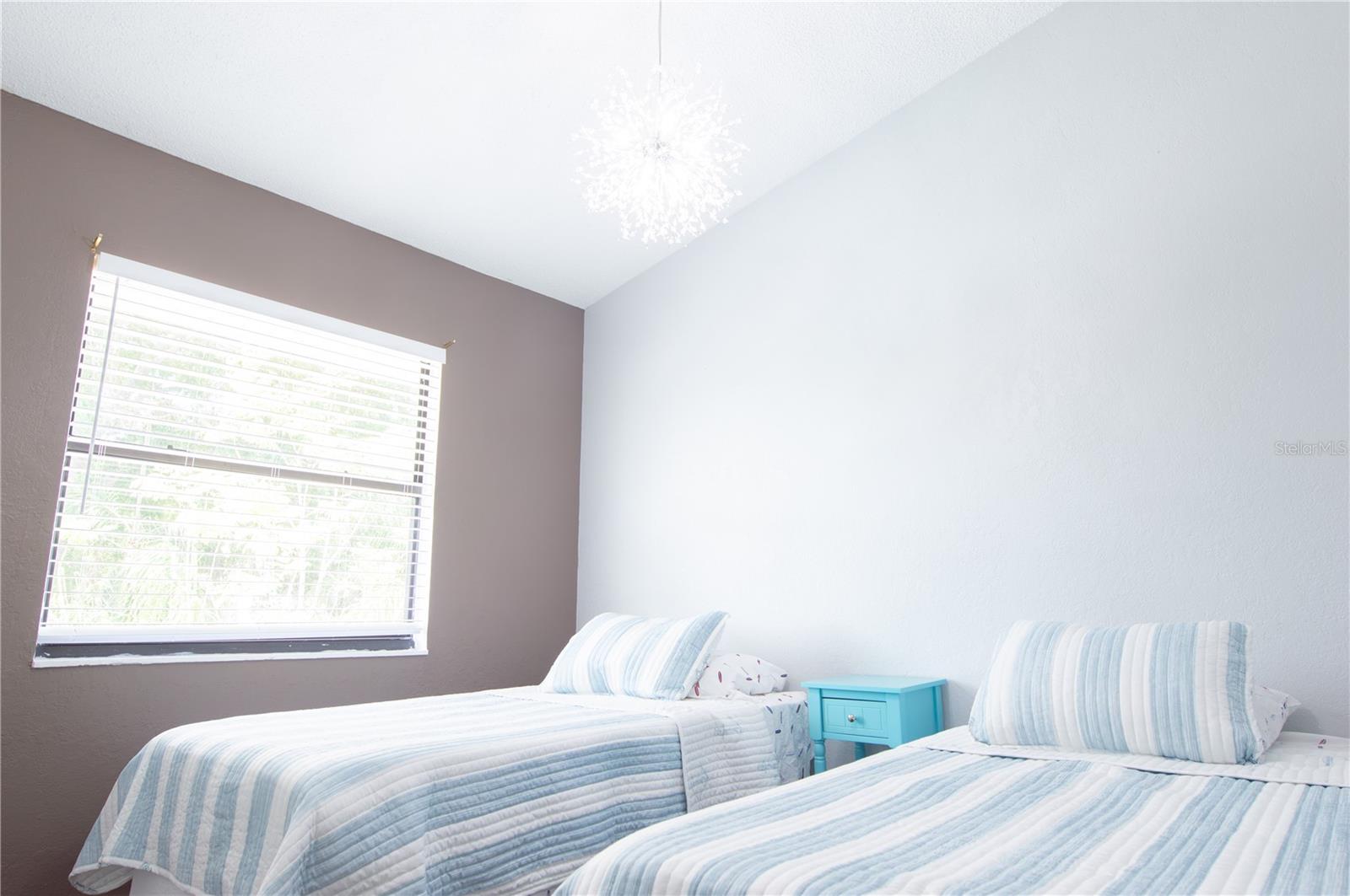 GUEST BEDROOM WITH 2 TWINS AND VAULTED CEILINGS.