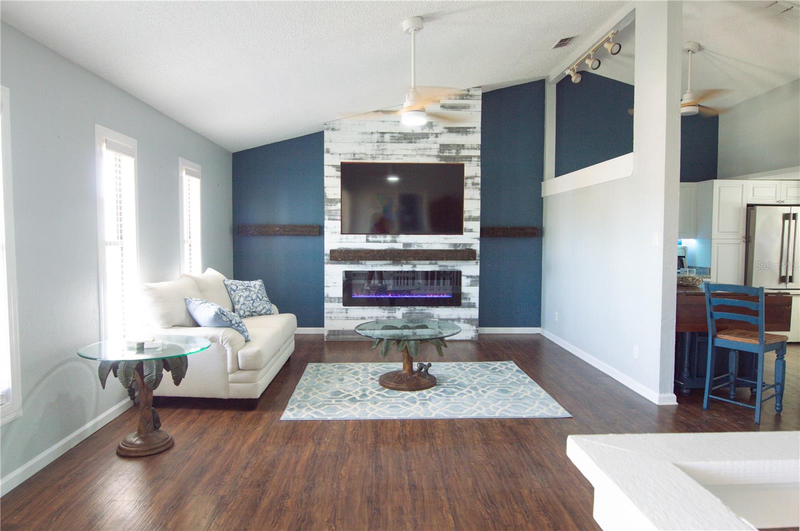 STUNNING GREAT ROOM WITH ELECTRIC RECESSED FIREPLACE & TV AND DURABLE LVP FLOORING.