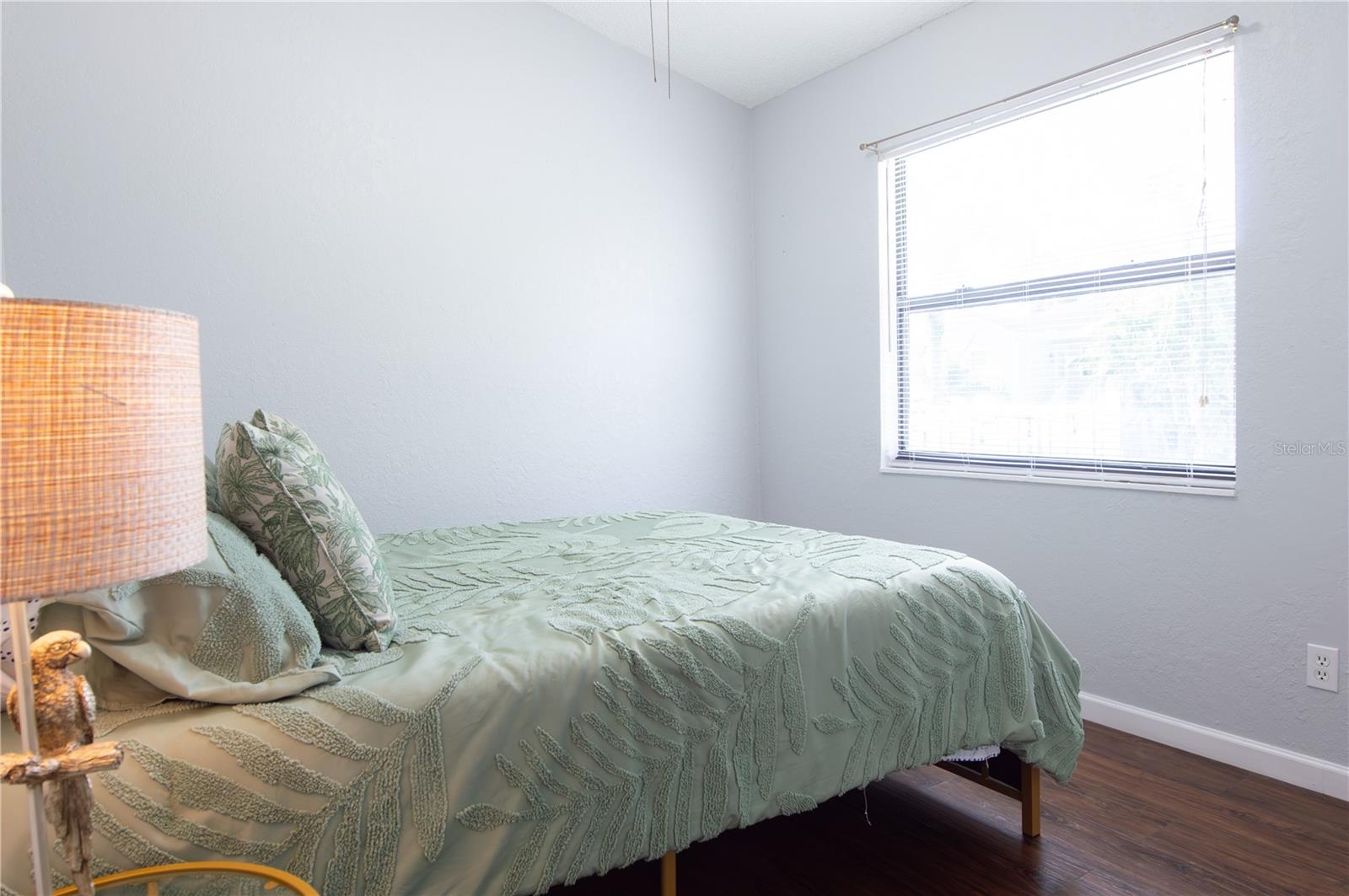 GUEST ROOM WITH VAULTED CEILING & CEILING FAN.