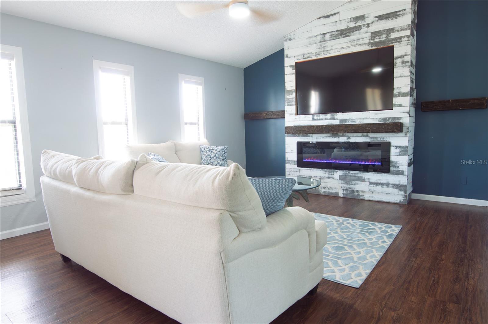 RECESSED ELECTRIC FIREPLACE AND BUILT-IN TV. THE LVP FLOORING AND VAULTED CEILINGS ARE THROUGH-OUT.