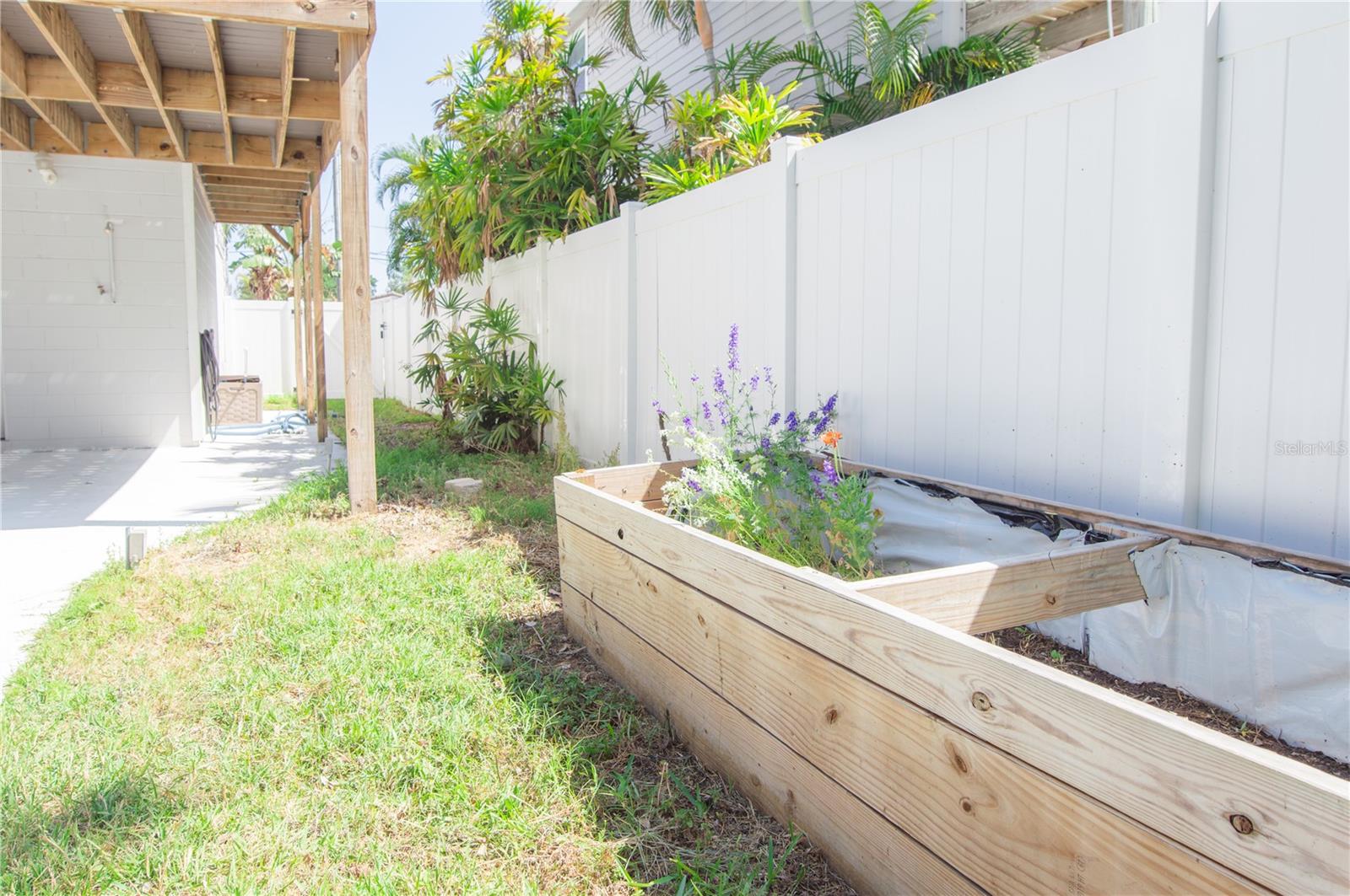 OUTDOOR RINSE-OFF SHOWER AND FLOWER/HERB GARDEN.