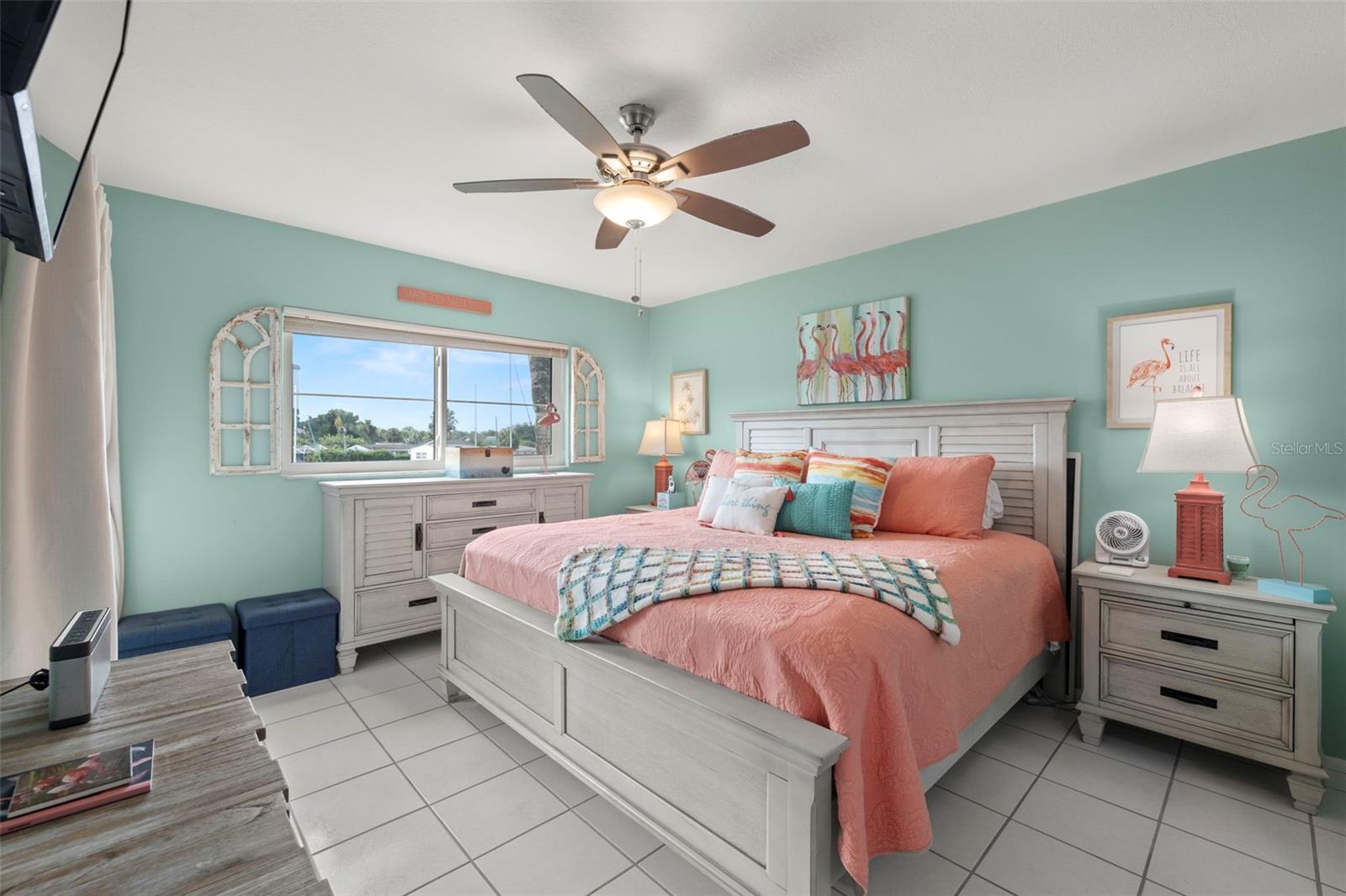 The primary bedroom is located toward the rear of the home.  Features ceramic tile, ceiling fan, scraped ceiling and can easily accommodate a king-sized bed.