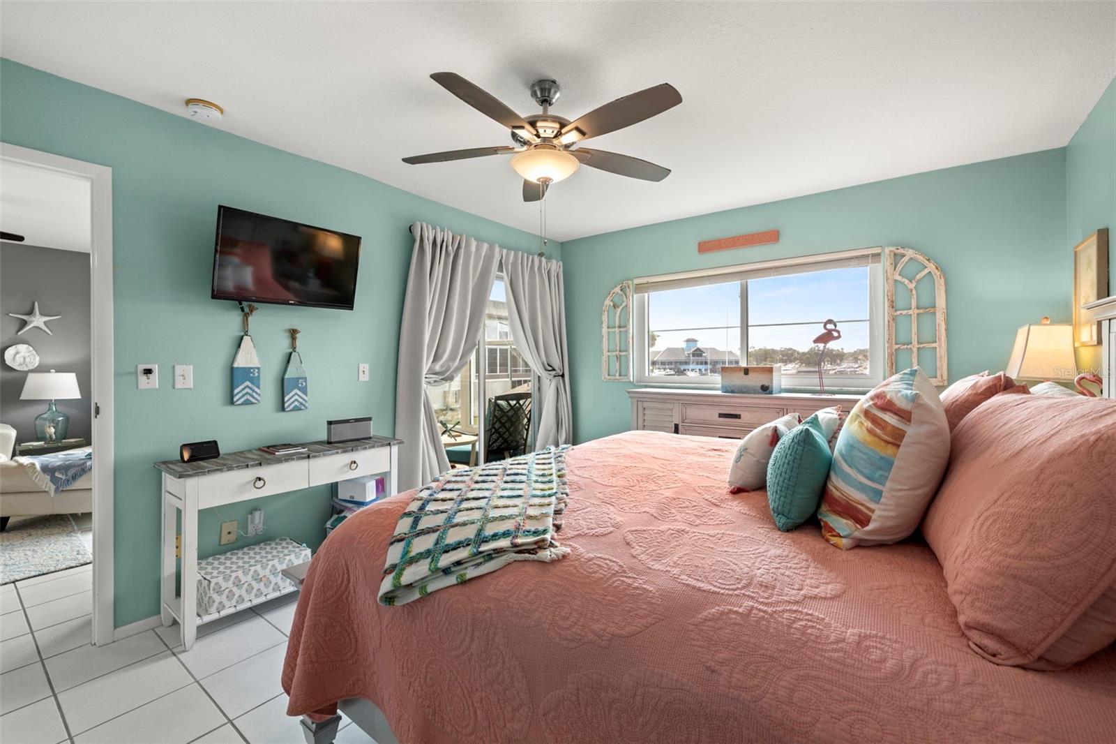 The primary bedroom includes sliding glass doors to the enclosed balcony. You can open up all those windows and feel the cool breeze!