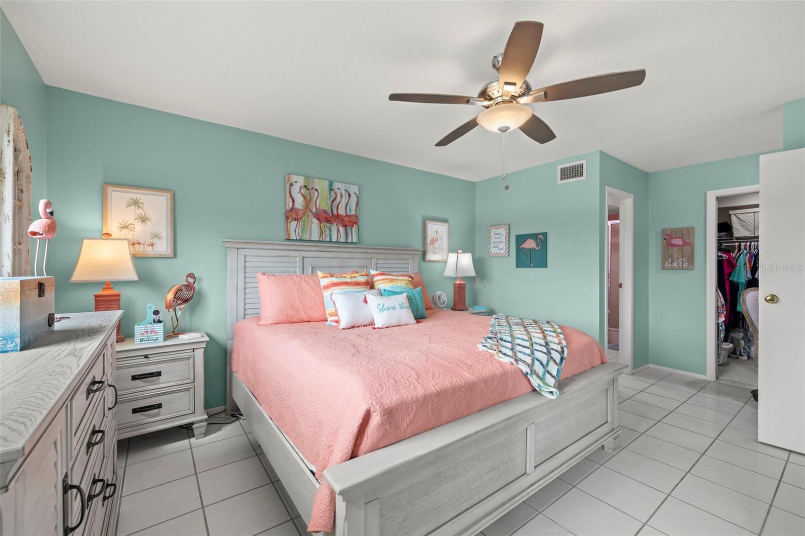 View toward the primary en-suite bathroom, walk-in closet and built in desk area.