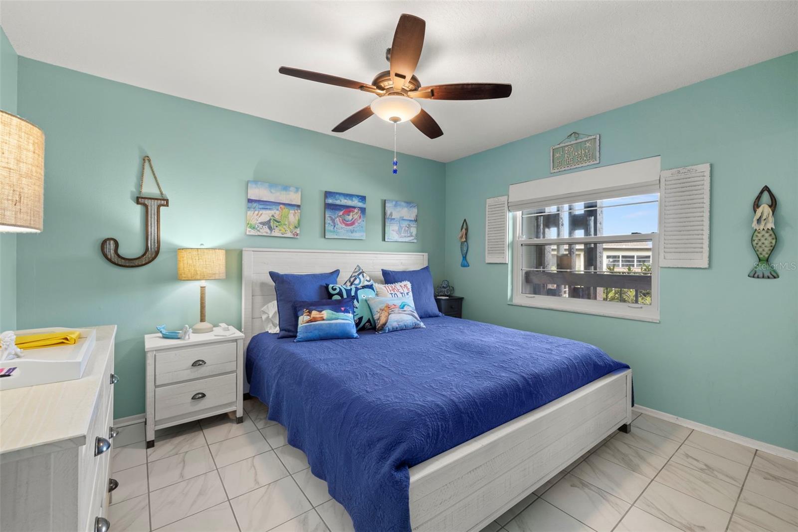 Secondary bedroom located toward the front of the home is also quite large! Features scraped ceilings, new window, ceiling fan, ceramic tile and cool/beach theme paint