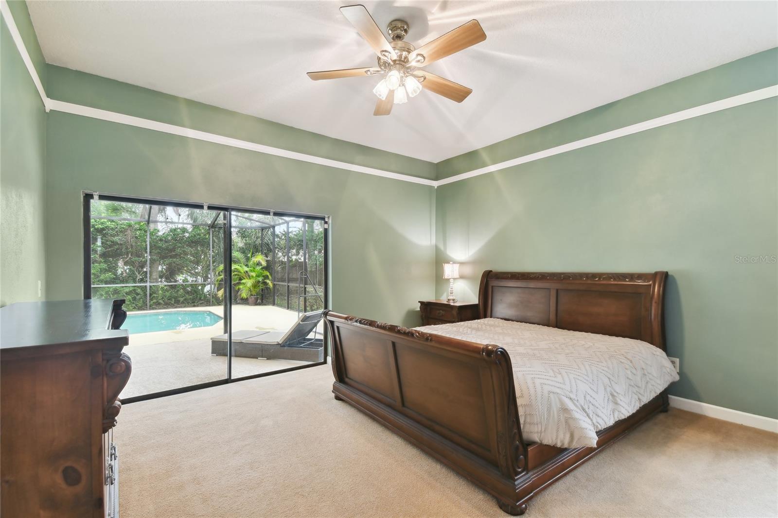 Master Bedroom with slider access and view of pool