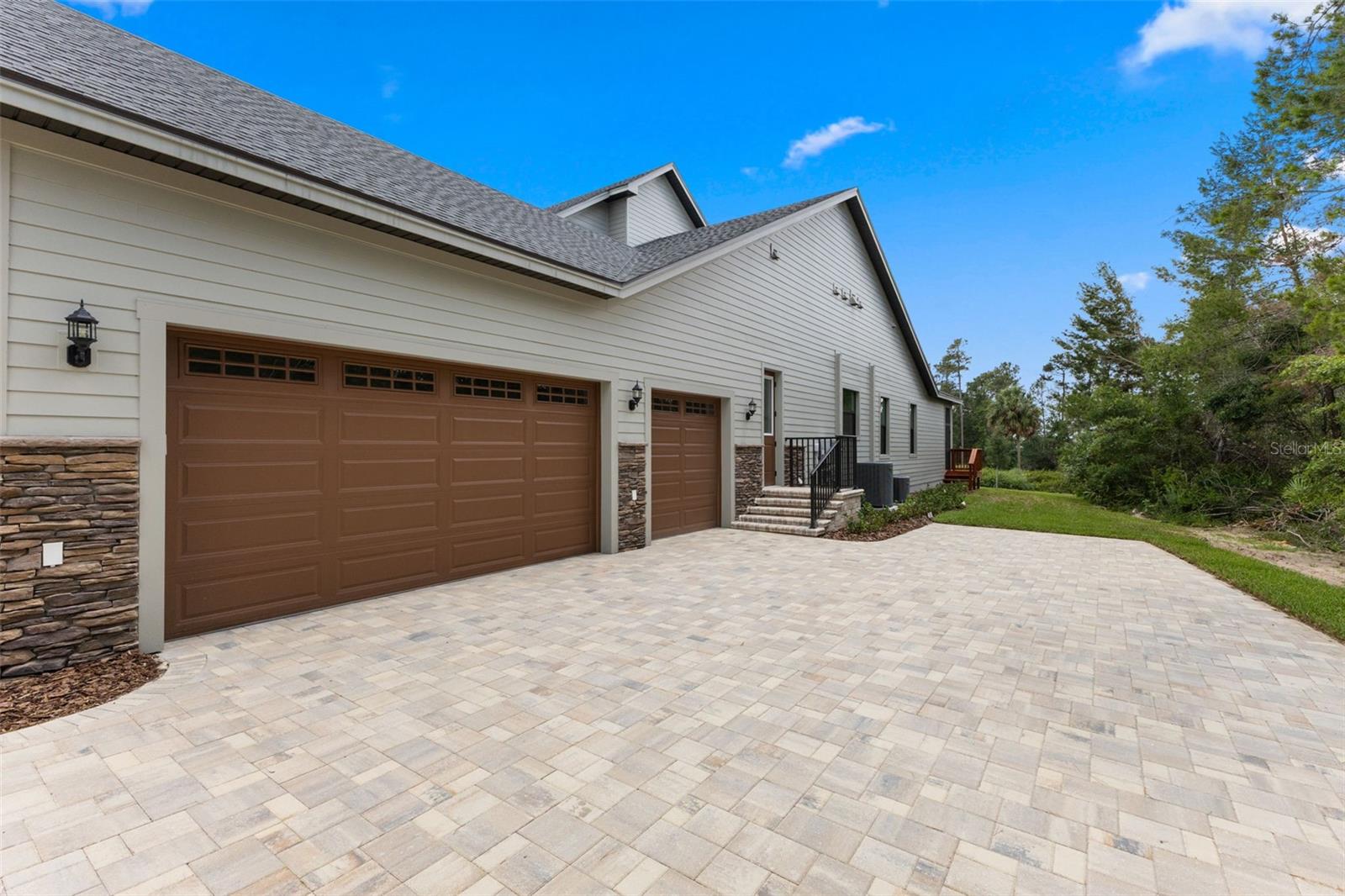 3 car garage and steps to side door entry and to the laundry area.