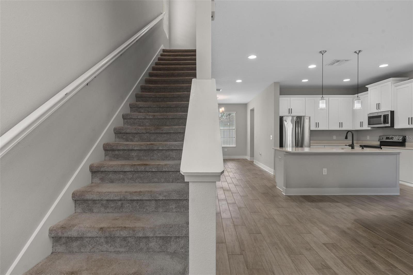 Stairs to bedrooms off foyer