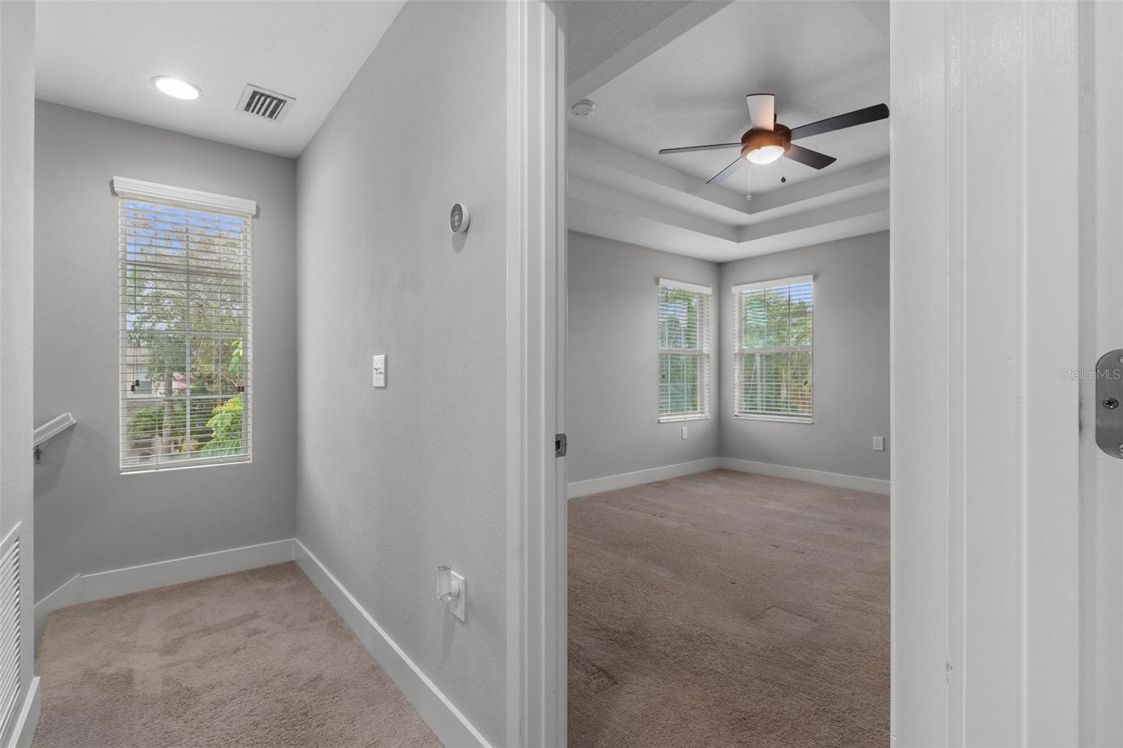 Entrance to primary bedroom off stairs