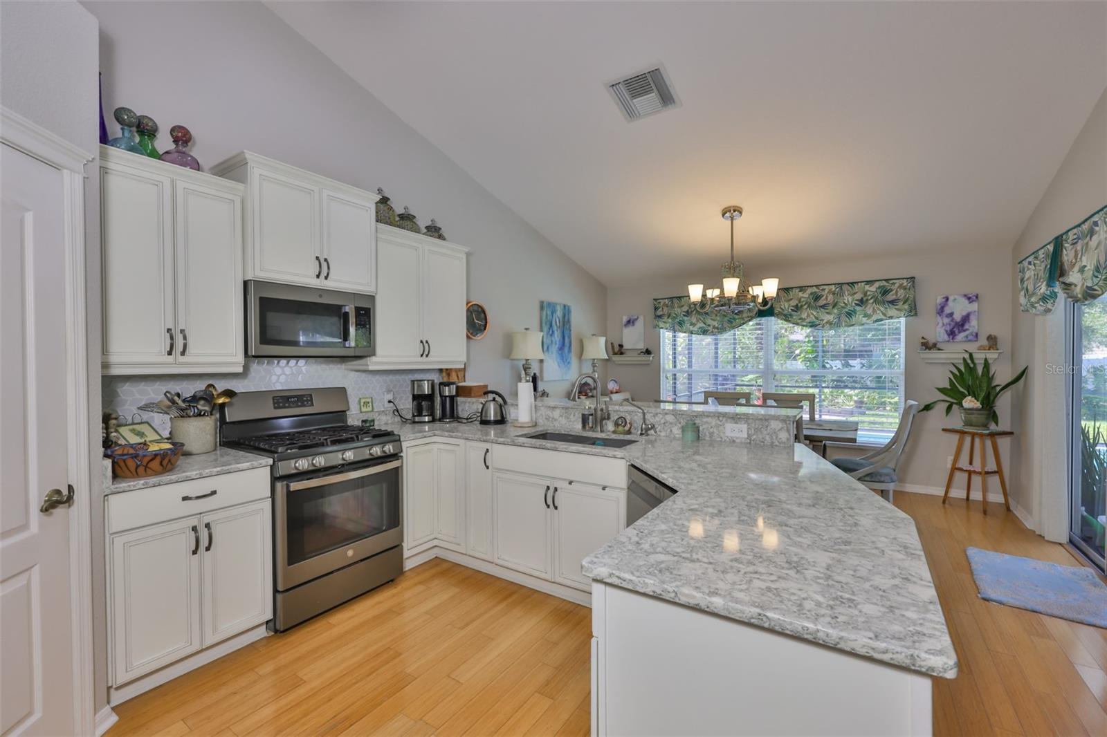 Attractive glass backsplash as well and views of the pool and lanai from the kitchen