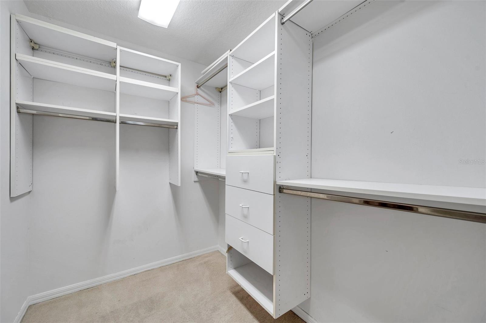 Walk in closet in primary bedroom