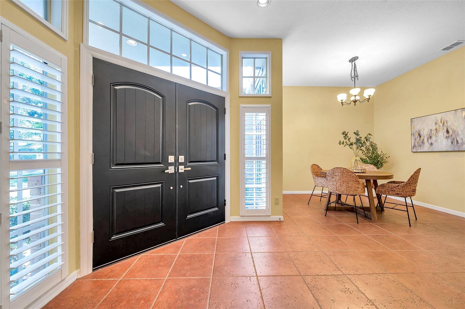 Plantation shutters at the windows at front door.
