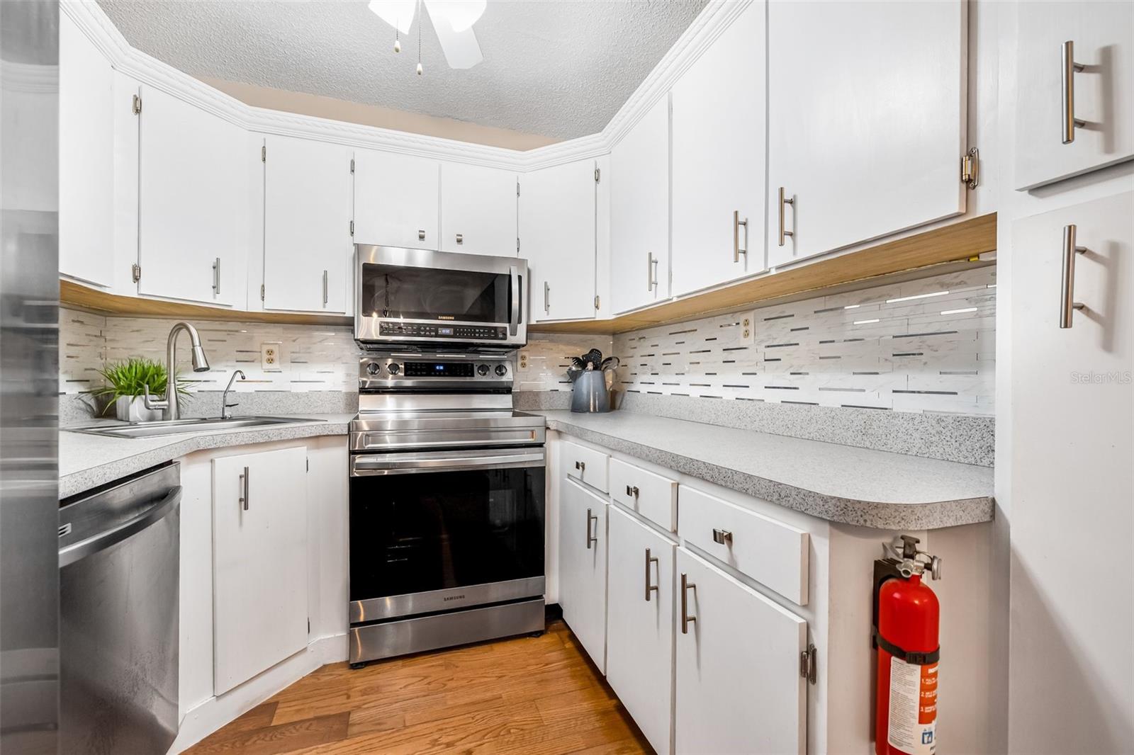 The kitchen features updated backsplash.