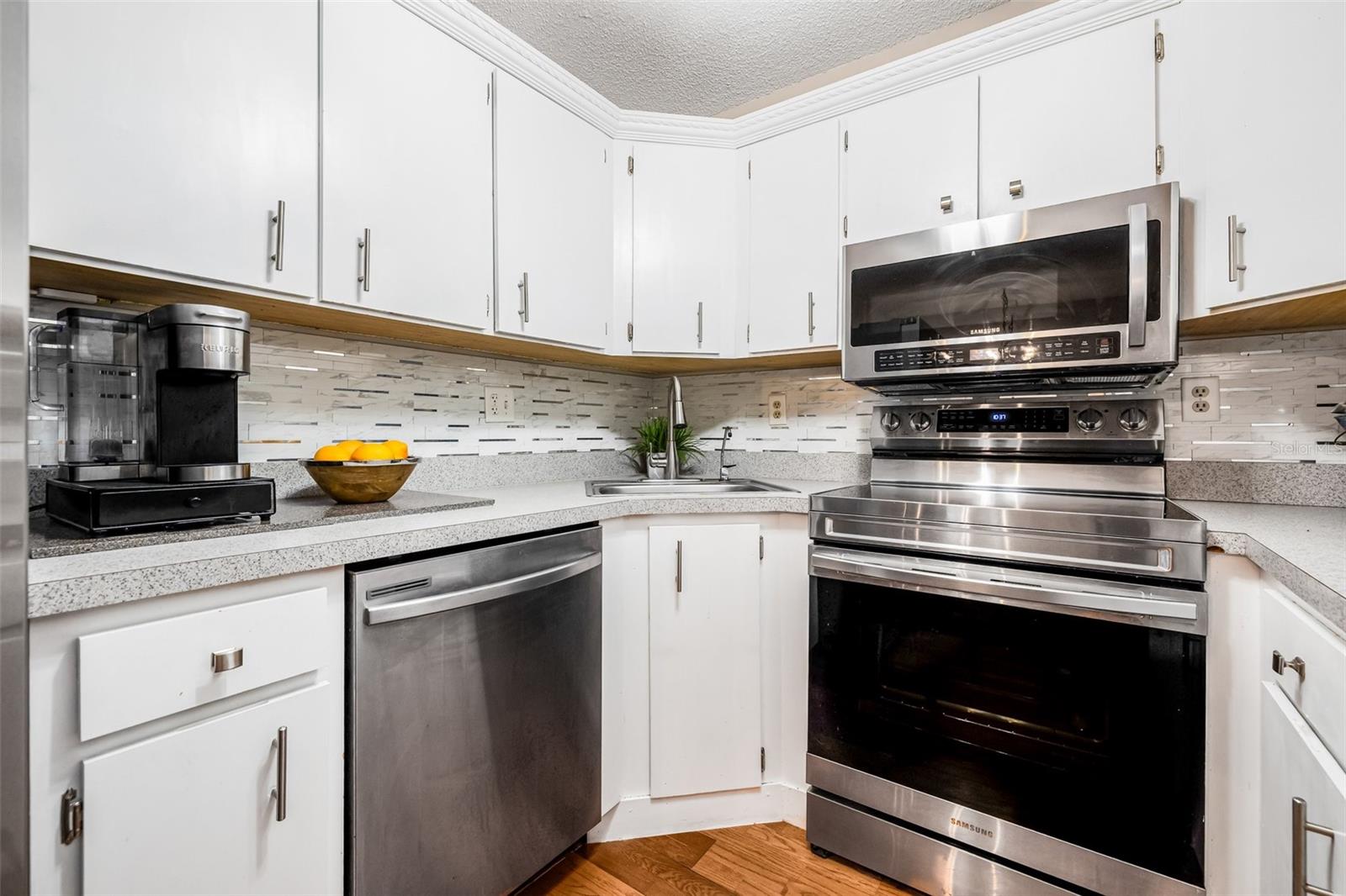 Another view of the kitchen - including a dishwasher, microwave, refrigerator, and stove—ideal for whipping up culinary masterpieces.