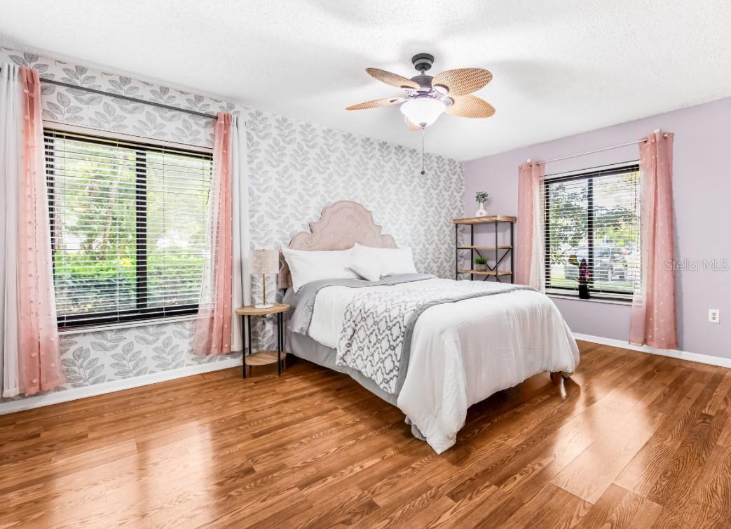 Master bedroom features beautiful peel and stick wallpaper - easily removable based on your own preference of stye and color. Newer Pella Impact resistant windows installed in 2020.