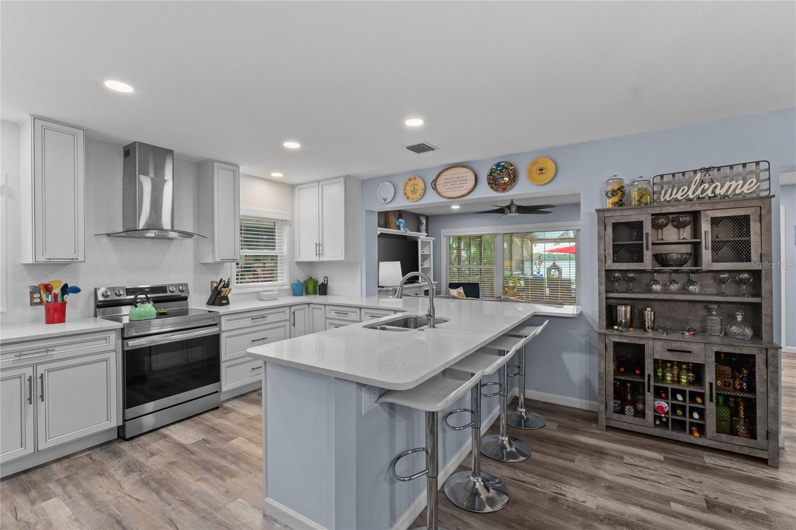 This Kitchen has it all - lots of storage, quartz countertops, a stylish tile backsplash and stainless steel appliances