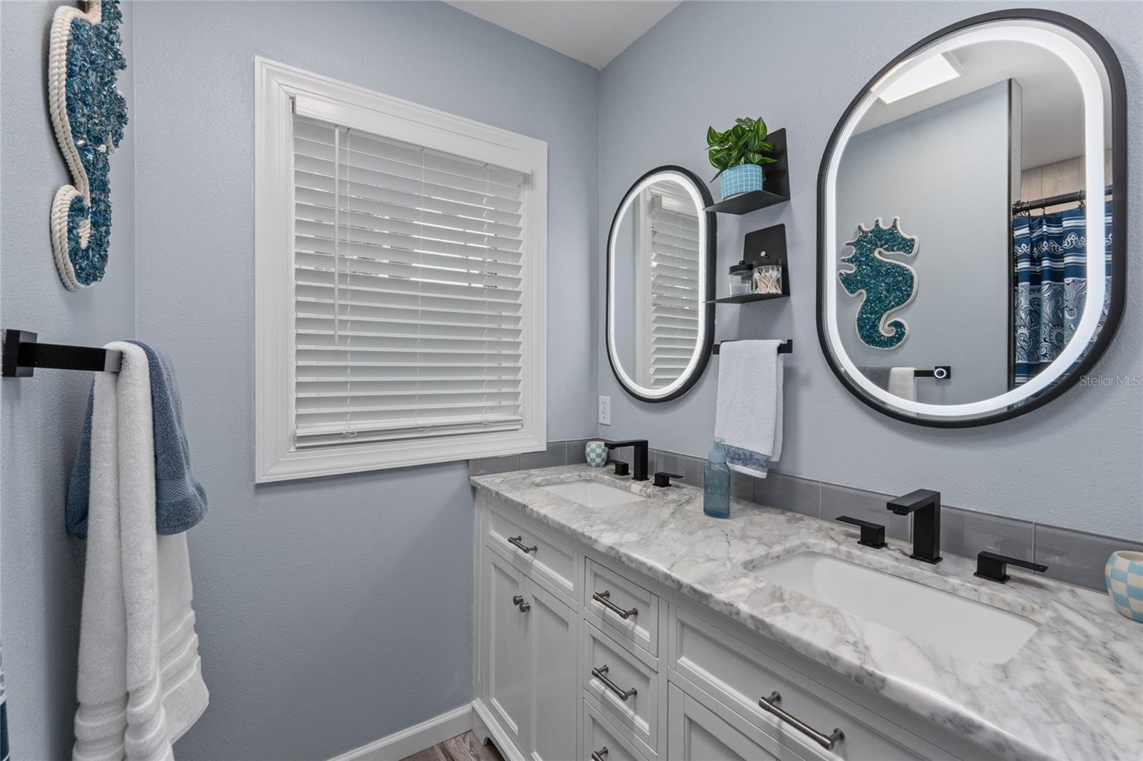 Primary Bathroom with dual sinks and a huge Shower with floor to ceiling tile
