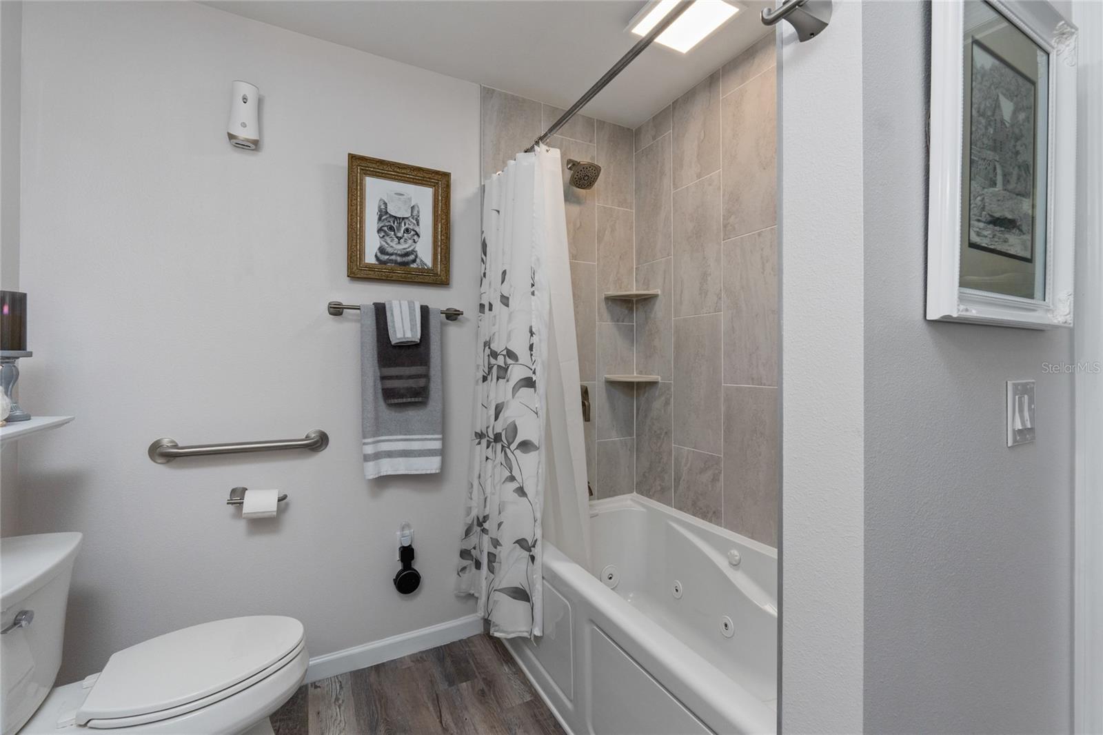 Bathroom 2 features a jetted tub and floor to ceiling tile