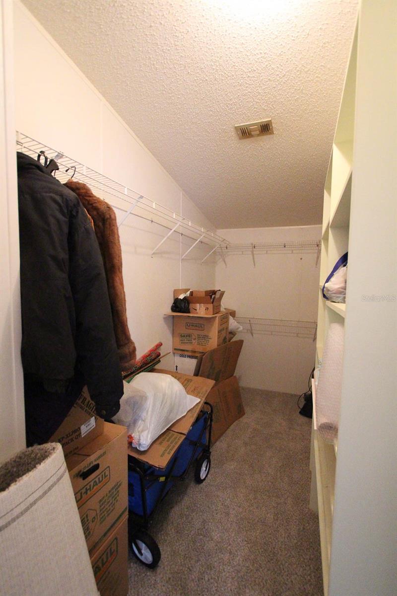Primary closet with entrance to bedroom & bathroom