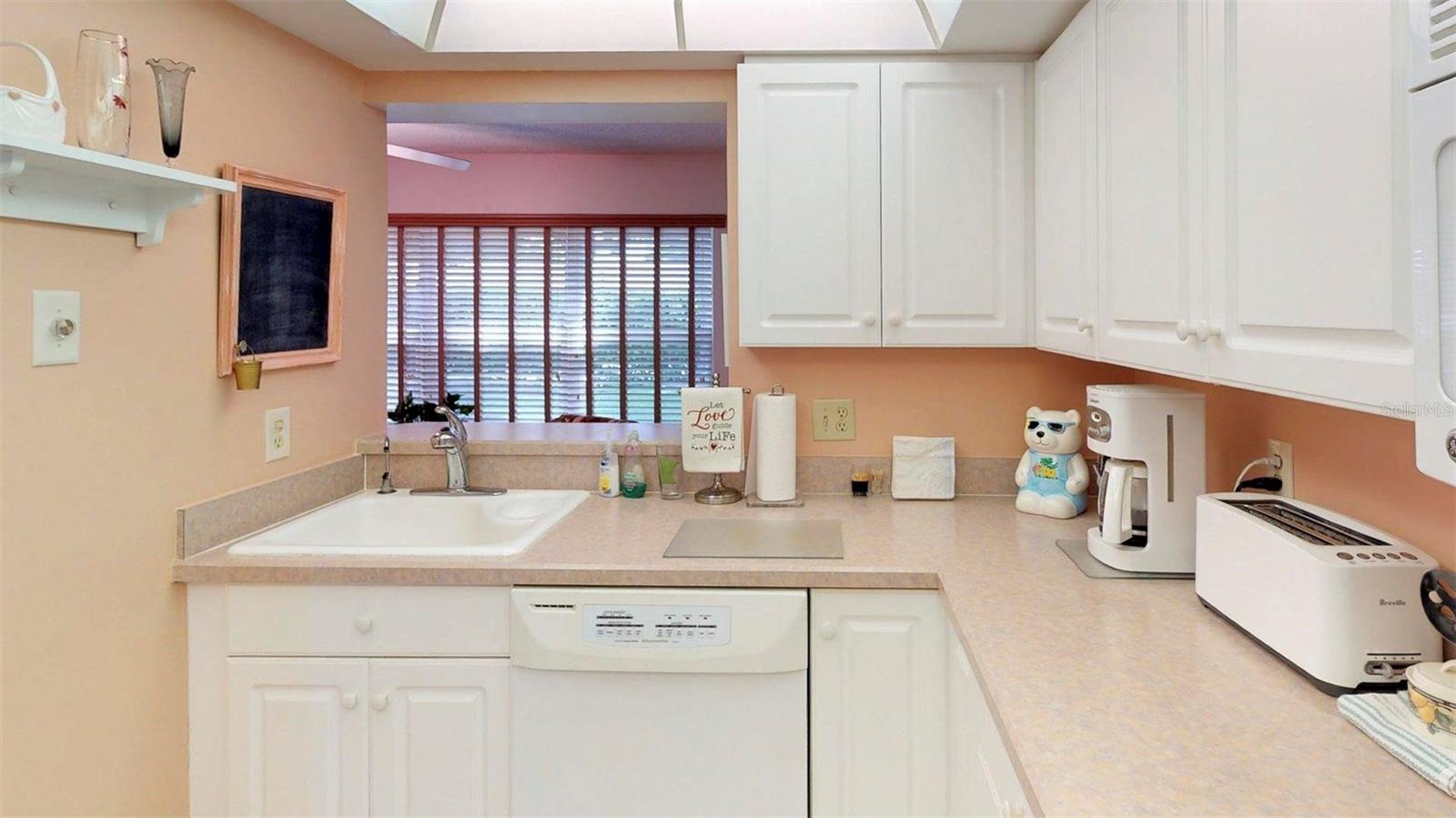 Kitchen offers a pass-through with view of the rear property.