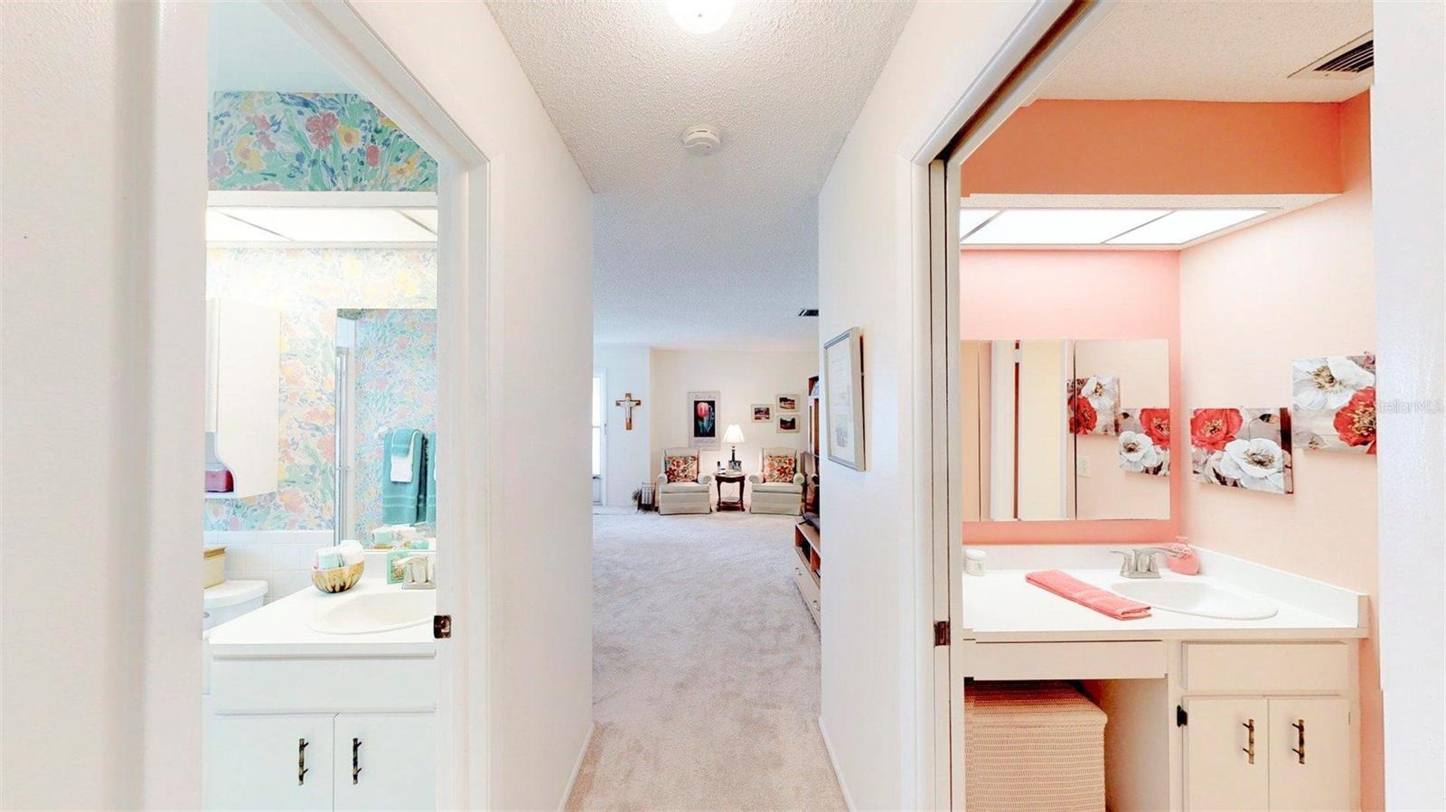The main bath on left, the primary bath on the right, looking into living room.