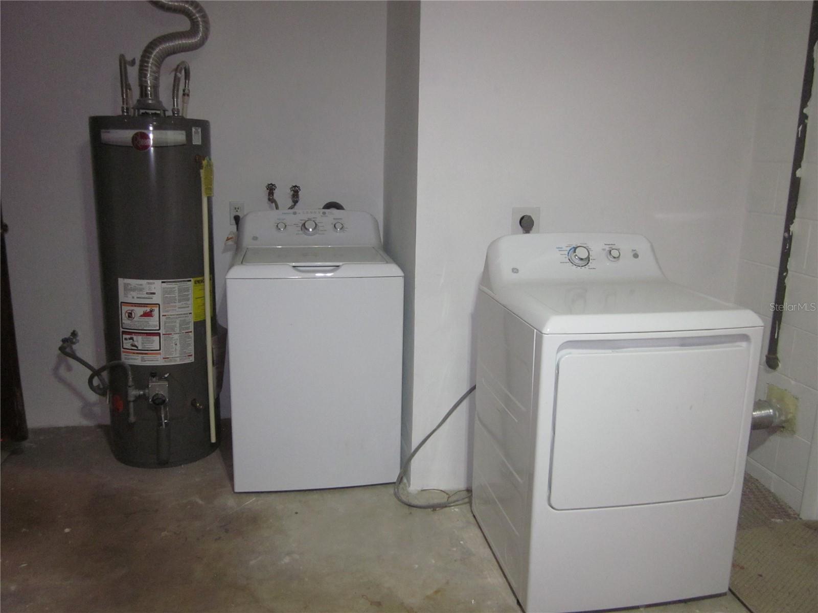 Gas hot water heater, with washer & dryer in garage