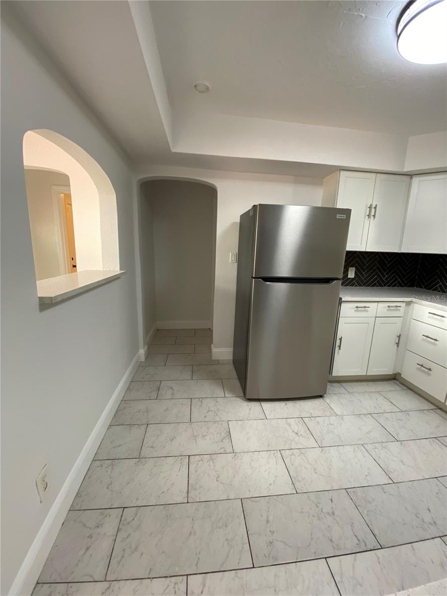 Kitchen view toward access doorway to dining room