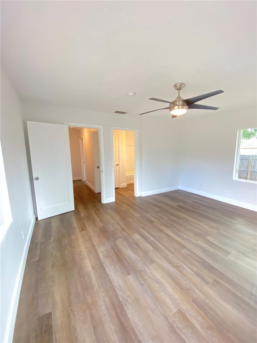 Rear view in third bedroom into the hall and on-suite second bathroom access doors