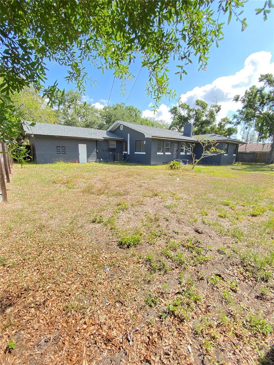 Rear corner view of backyard toward right side of house by garage