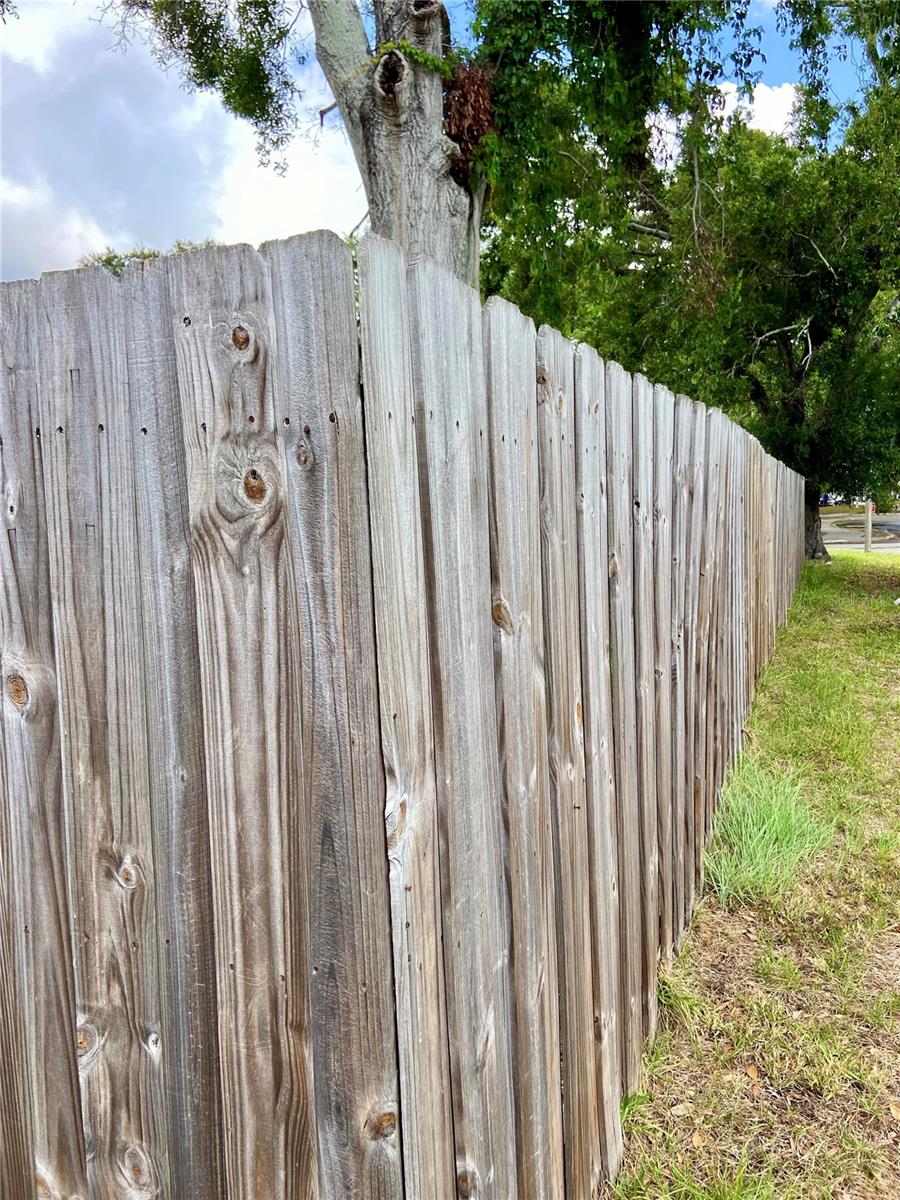 Corner fence view of left side of house
