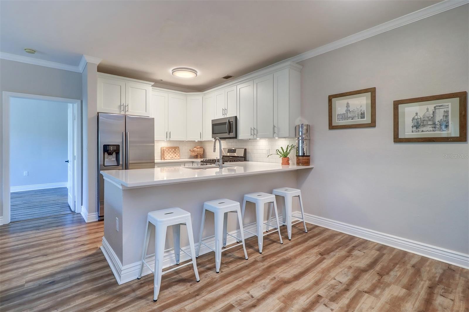 Kitchen eat in area between kitchen island and wine/coffee/dry bar