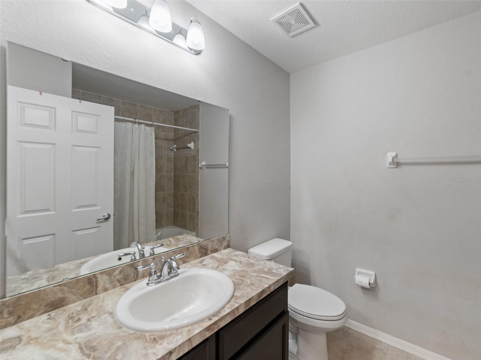 Upstairs Bathroom #2 with a tub