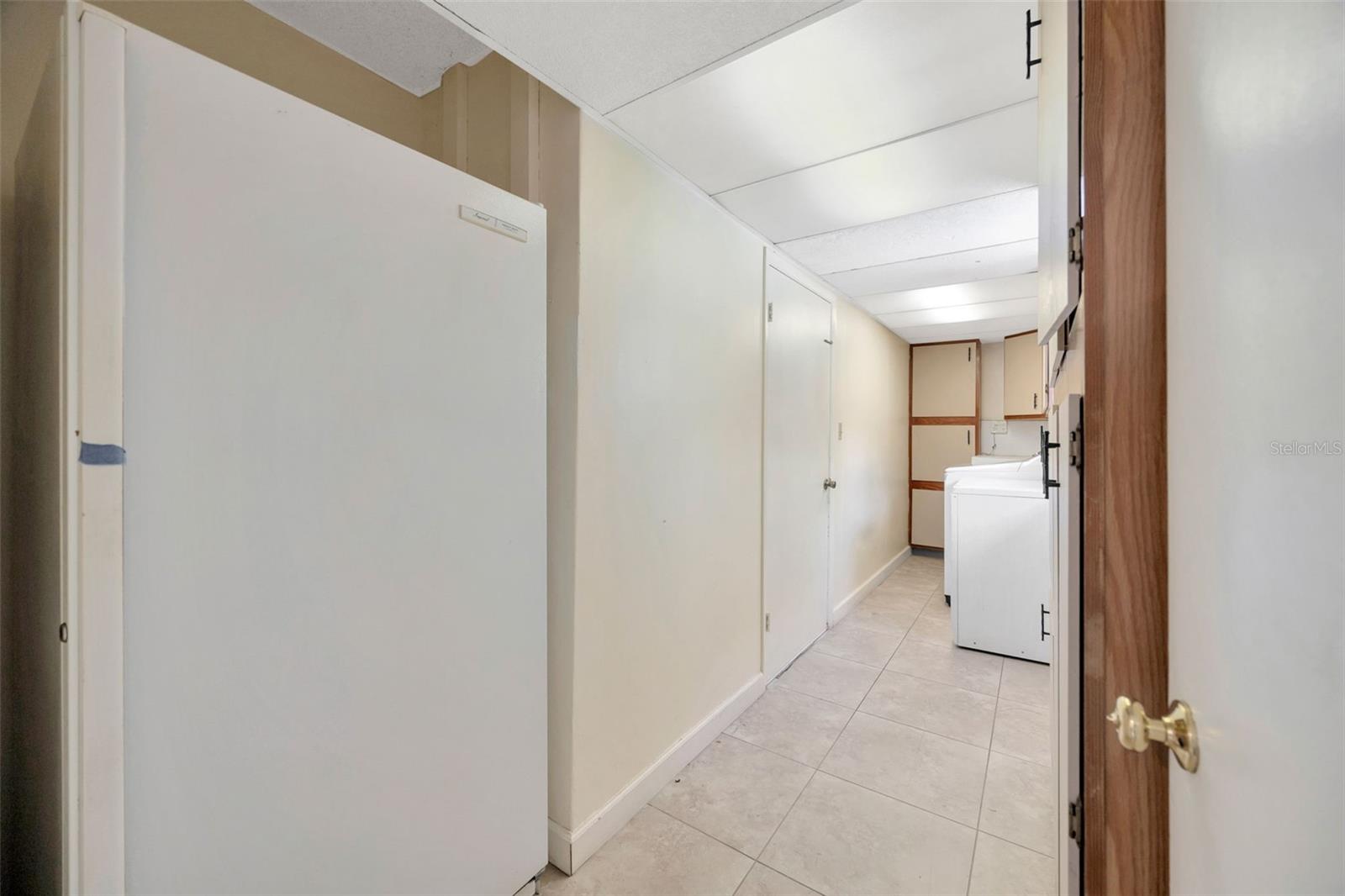 Laundry room off of kitchen - deep freezer in foreground