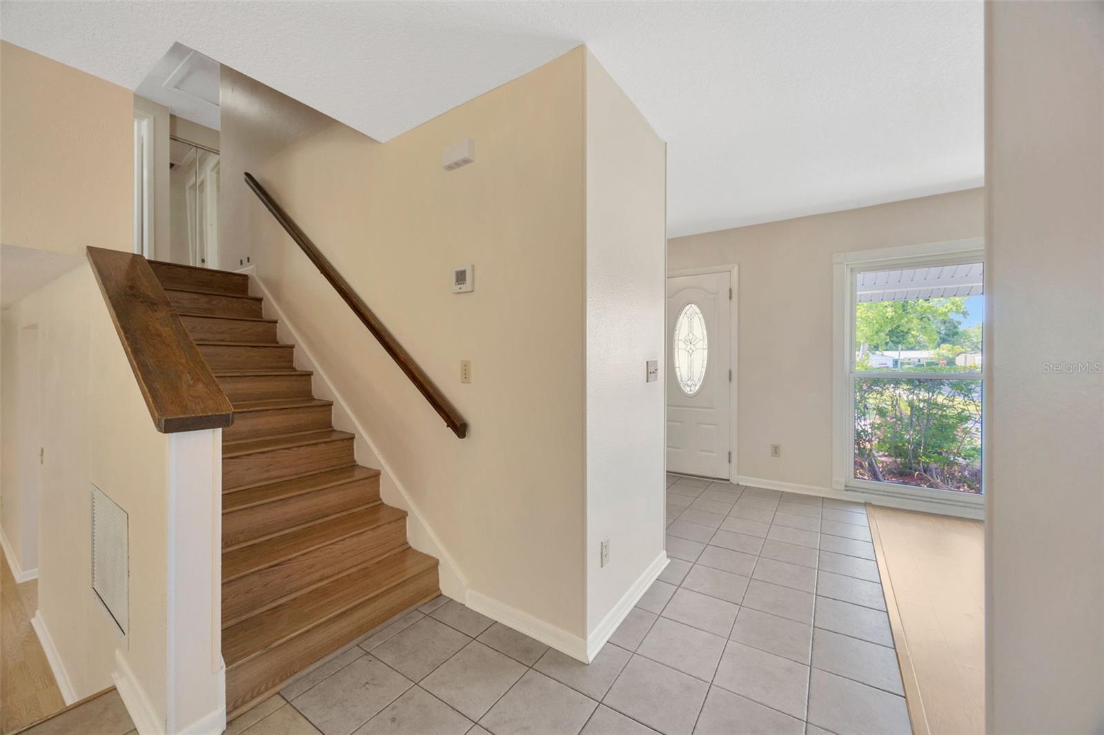 Stairs and view of front door