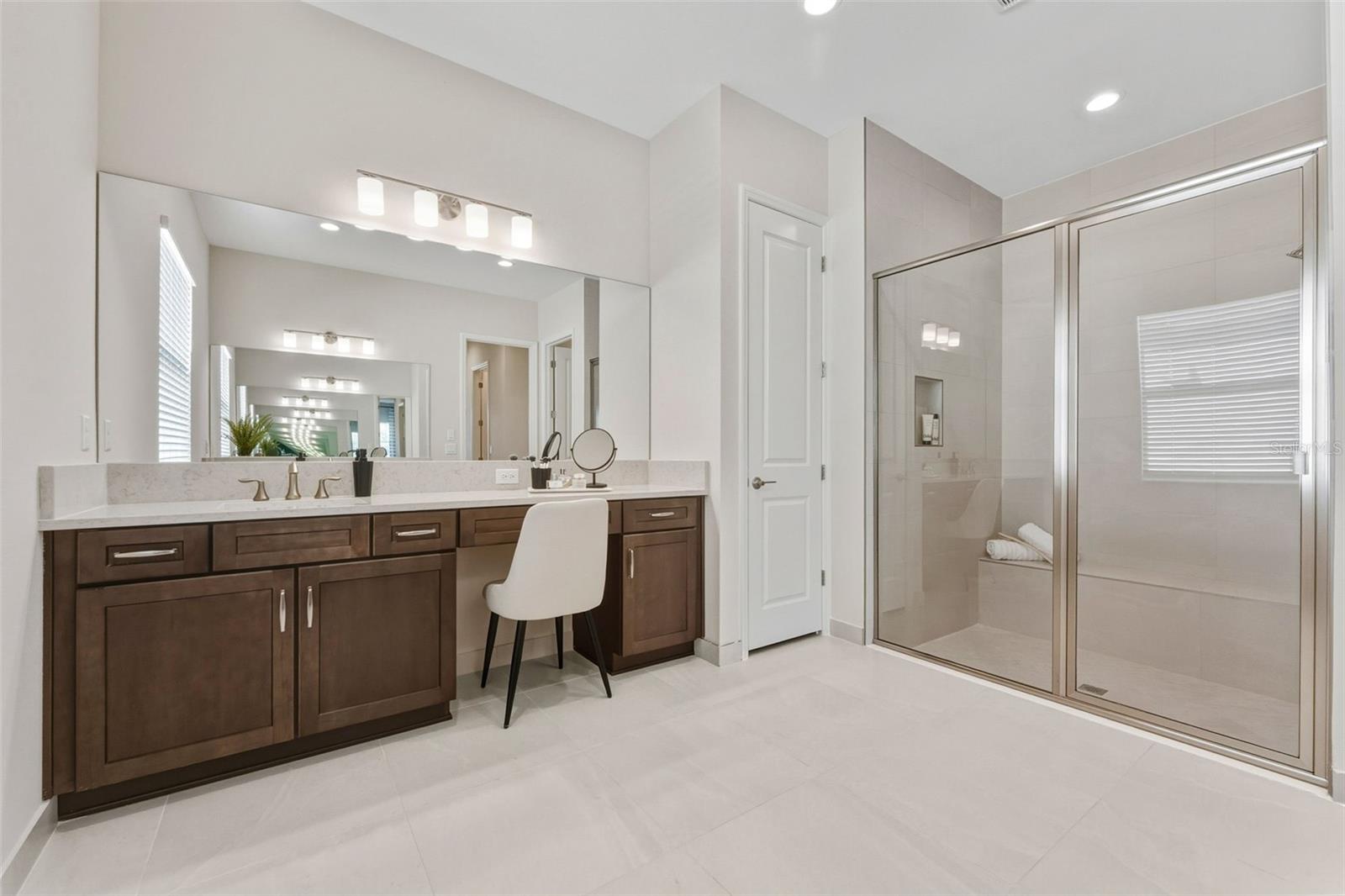 Oversized Master Bathroom With Dual Sink Extended Vanity and Walk-In Shower With Bench Seating